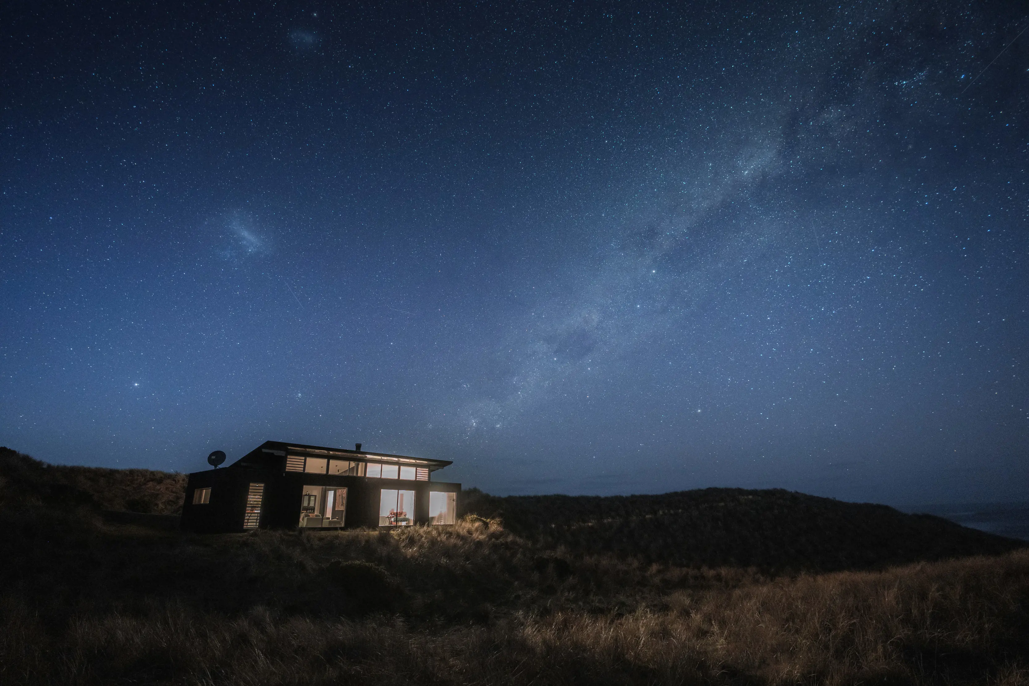Landscape image of Kittawa Lodge at night with the sky full of stars.