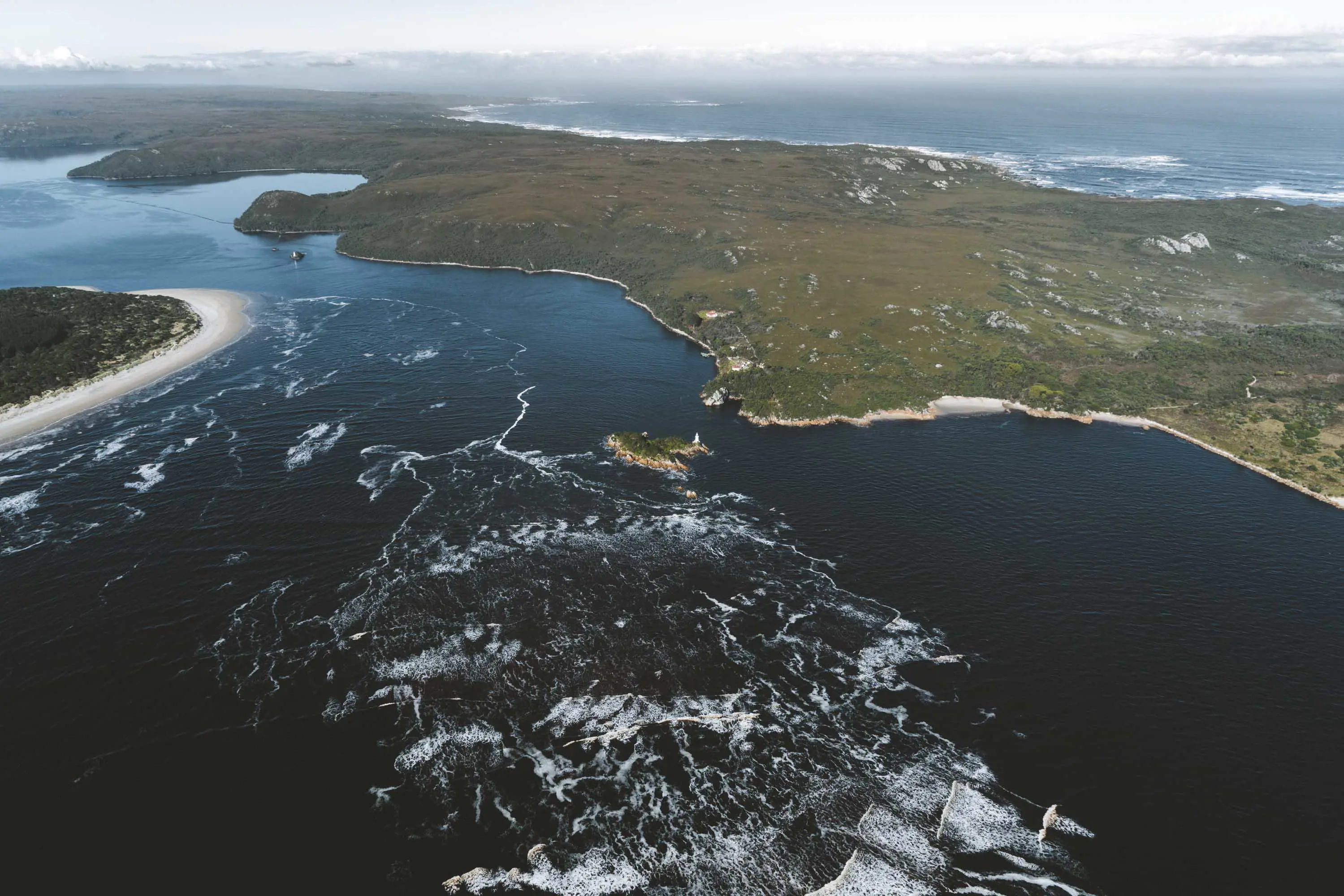 An aerial photograph of dark, rough waters in a large bay.