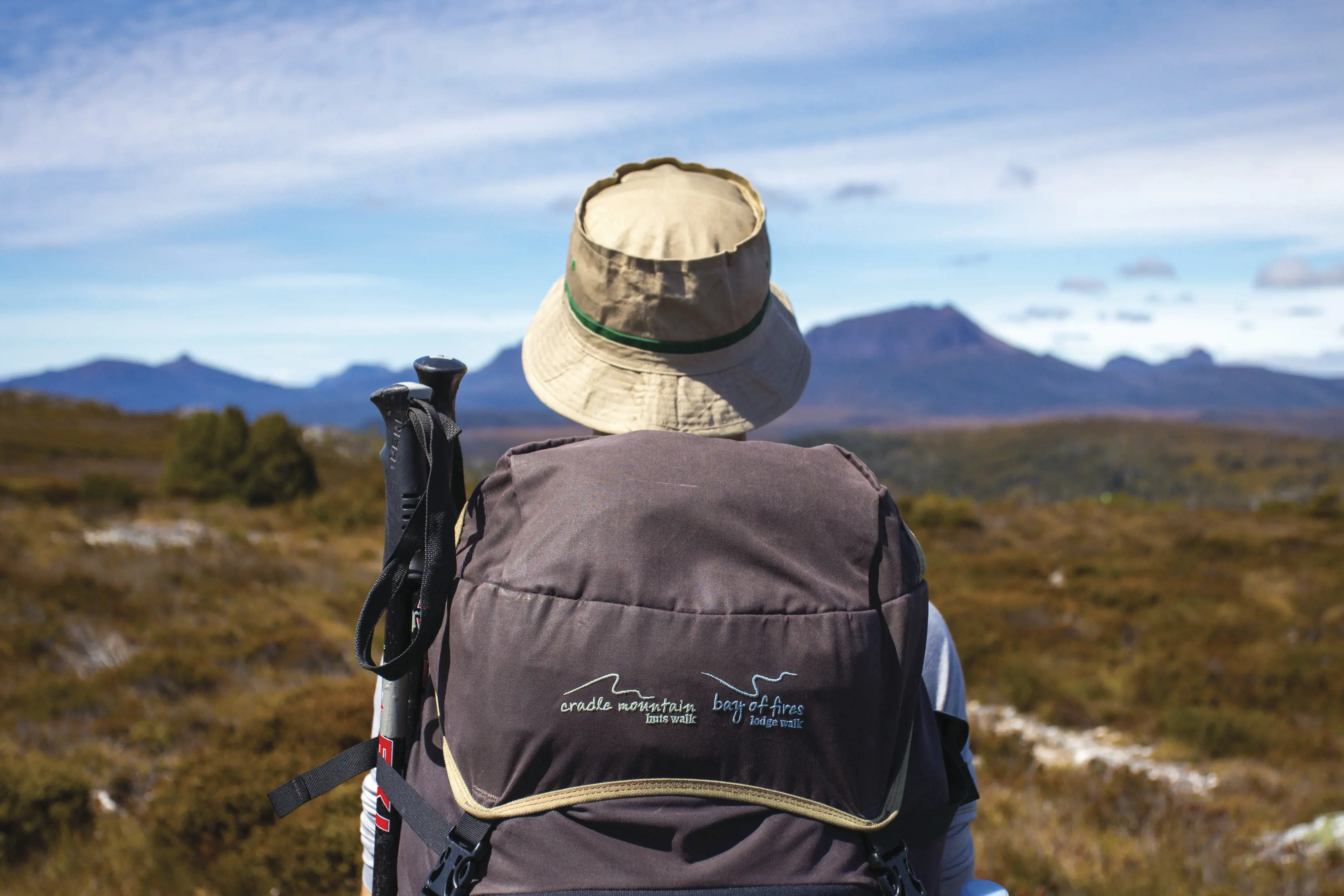 Shot from behind a hiker on the Cradle Mountain Huts Walk