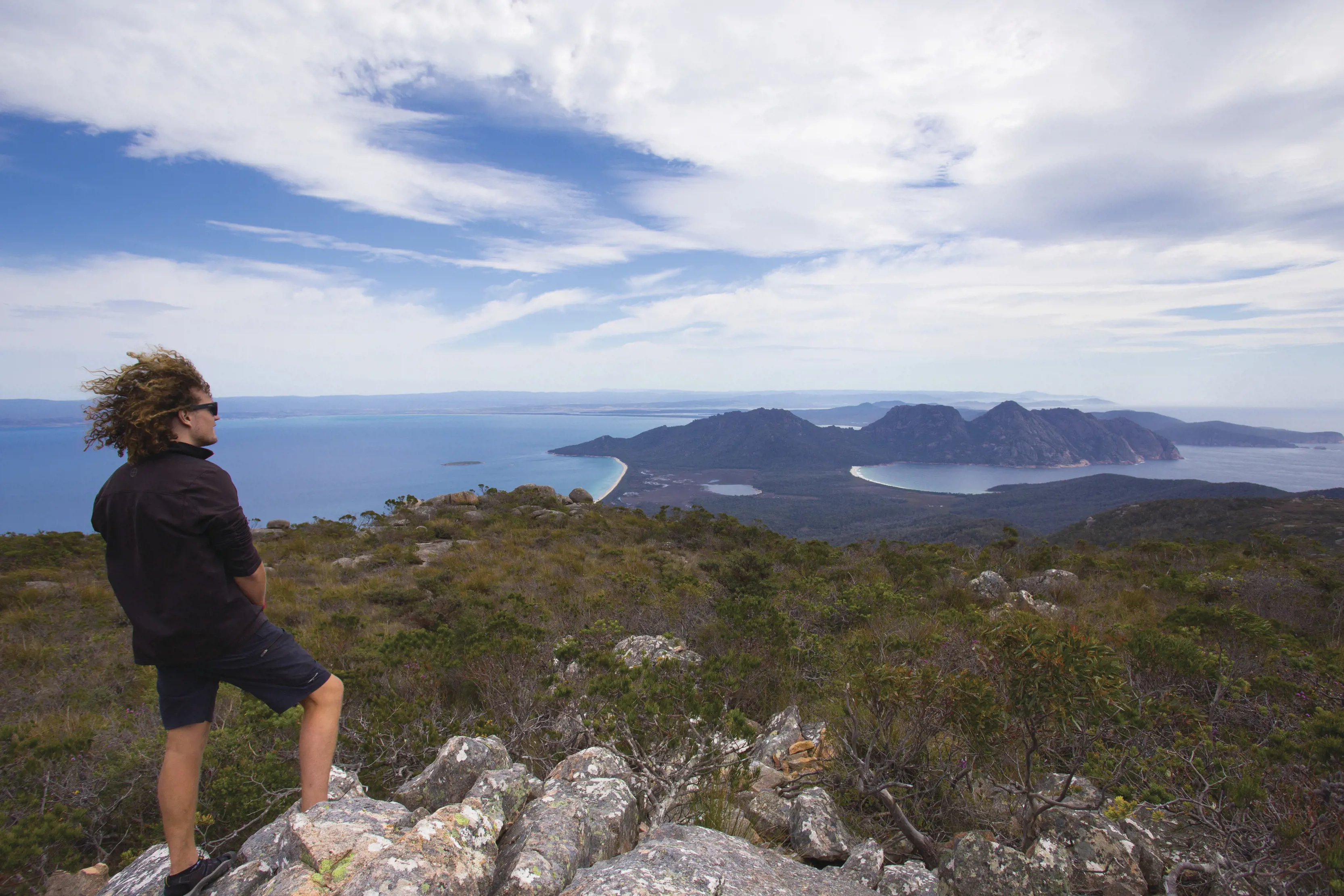 Hiker on Mount Graham, looking over Wineglass Bay
