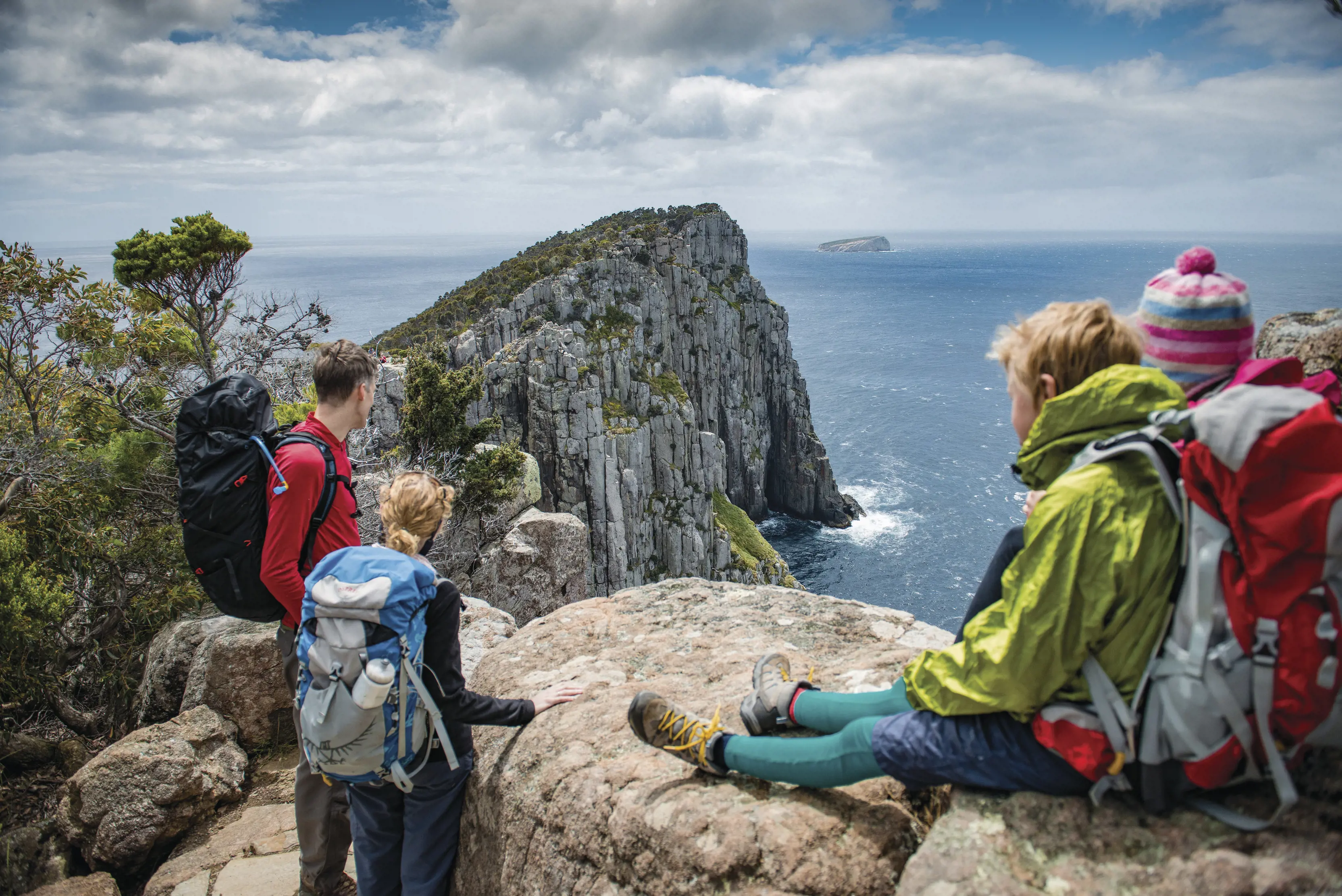 A family stop and look at the views at a cliff top, Three Capes Track - Cape Hauy.