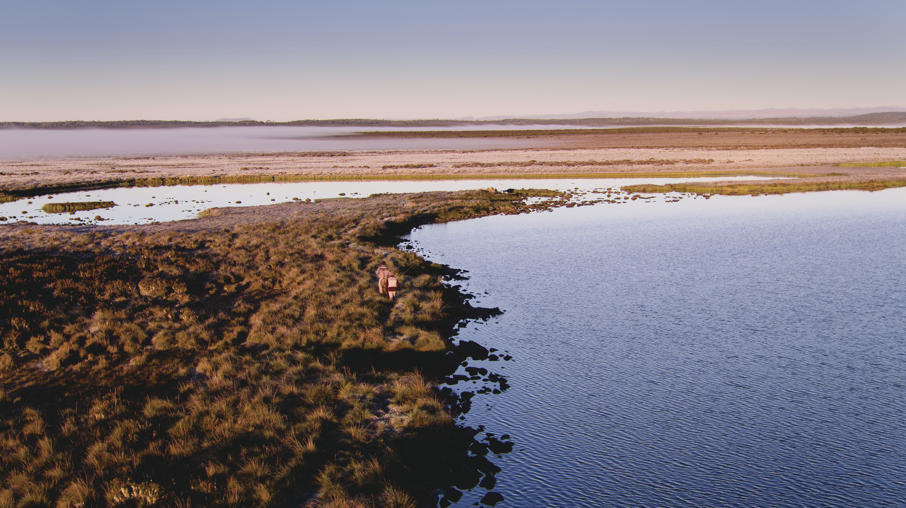 Aerial of Nineteen Lagoons, two people look small amongst the empty landscape.