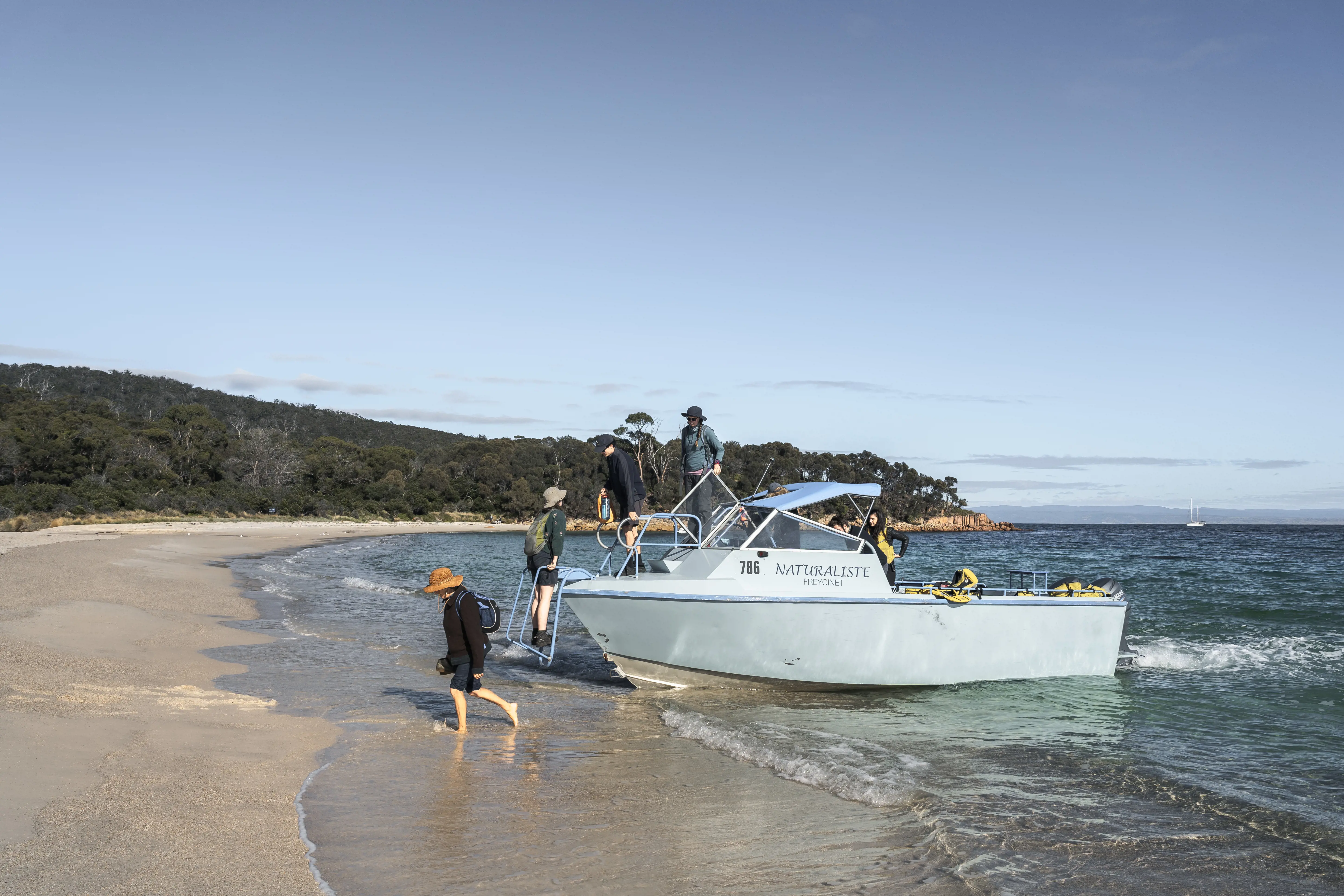 Tour group arriving by boat for the Freycinet Experience Walk