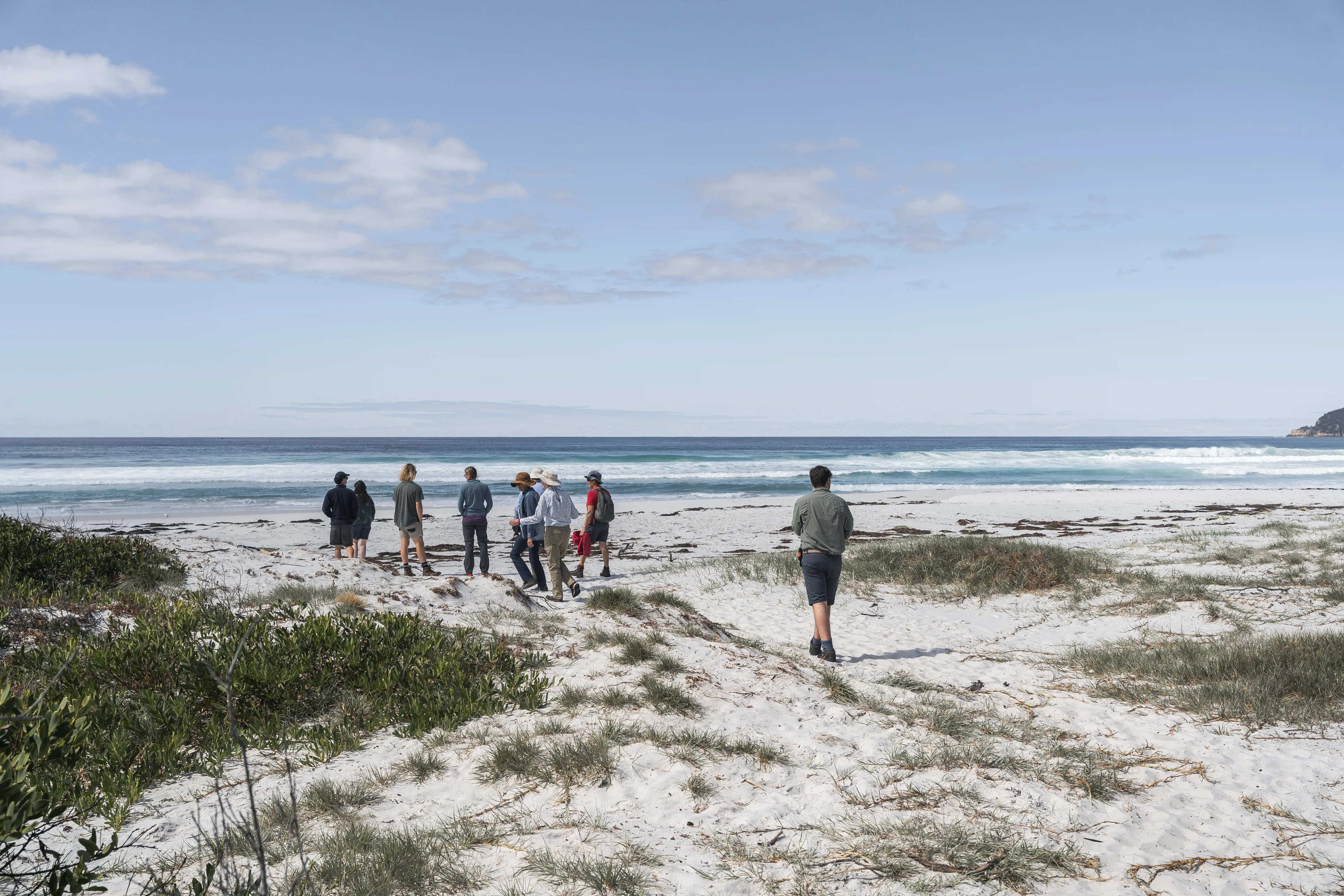 Group of people on the beach the Freycinet Experience Walk