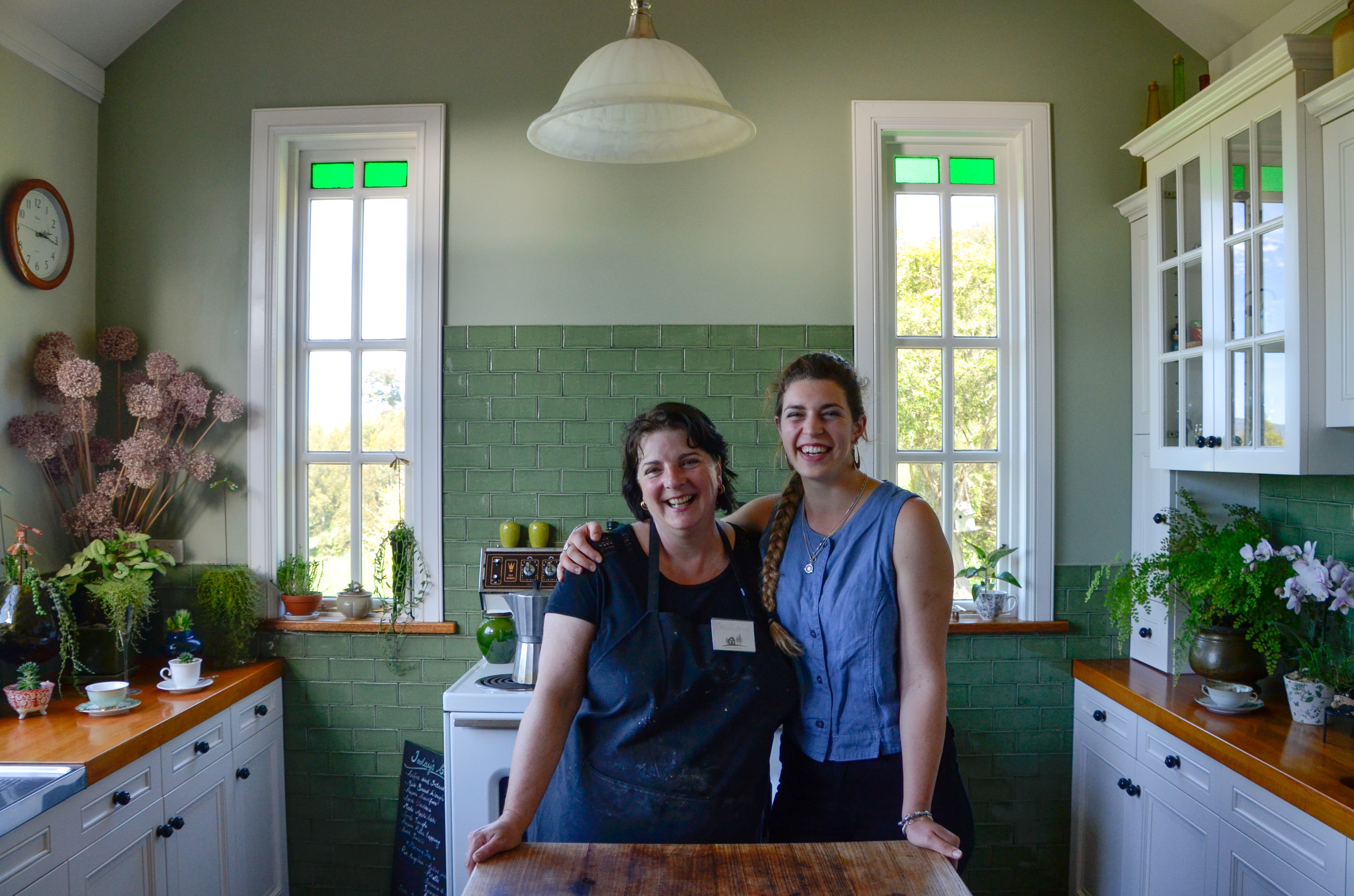 Two people posing for photo in the beautiful interior of The Farmhouse Kitchen.