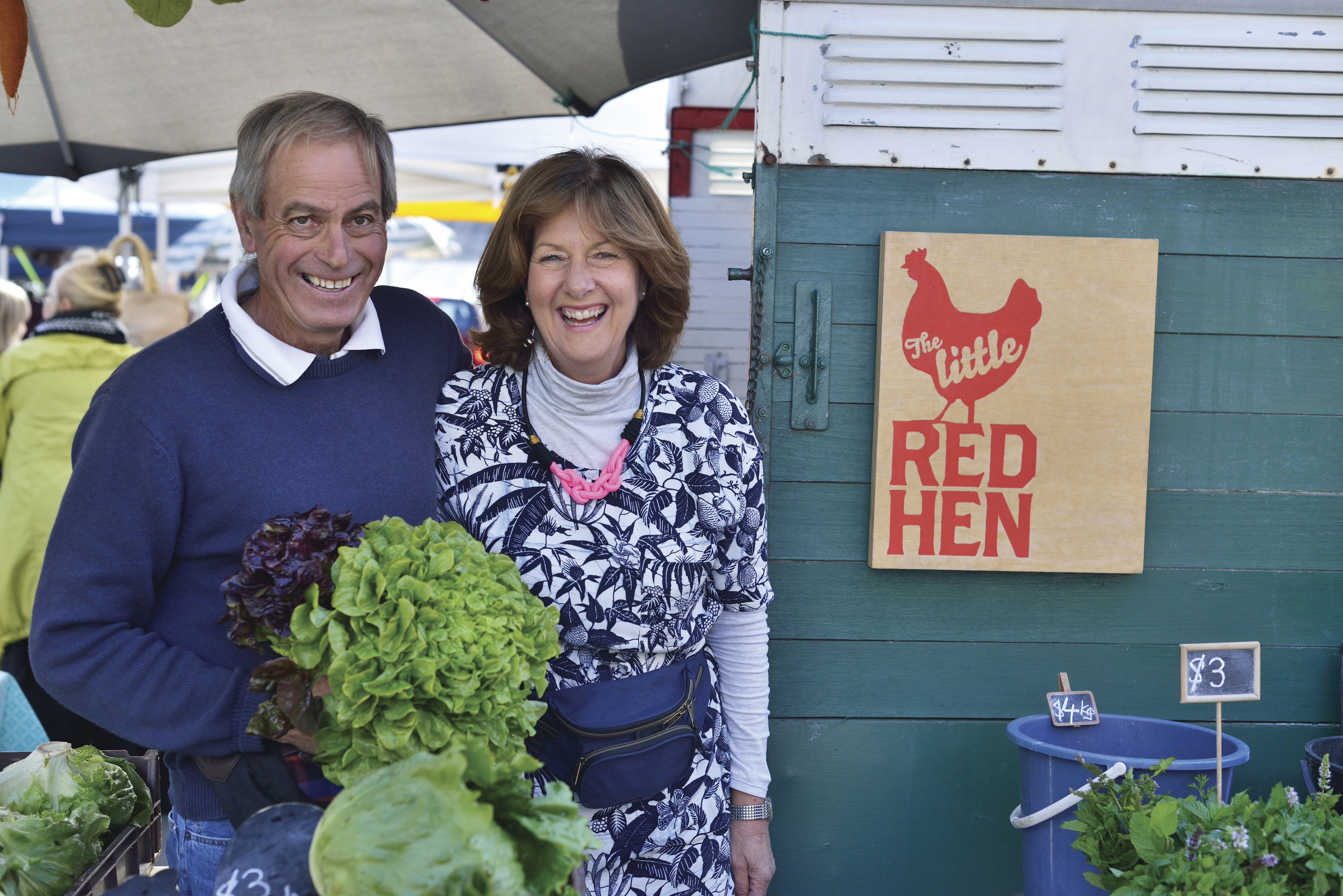 Couple holding produce at Farm Gate Market, Hobart’s weekend morning hotspot. The largest farmers’ markets in Tasmania.