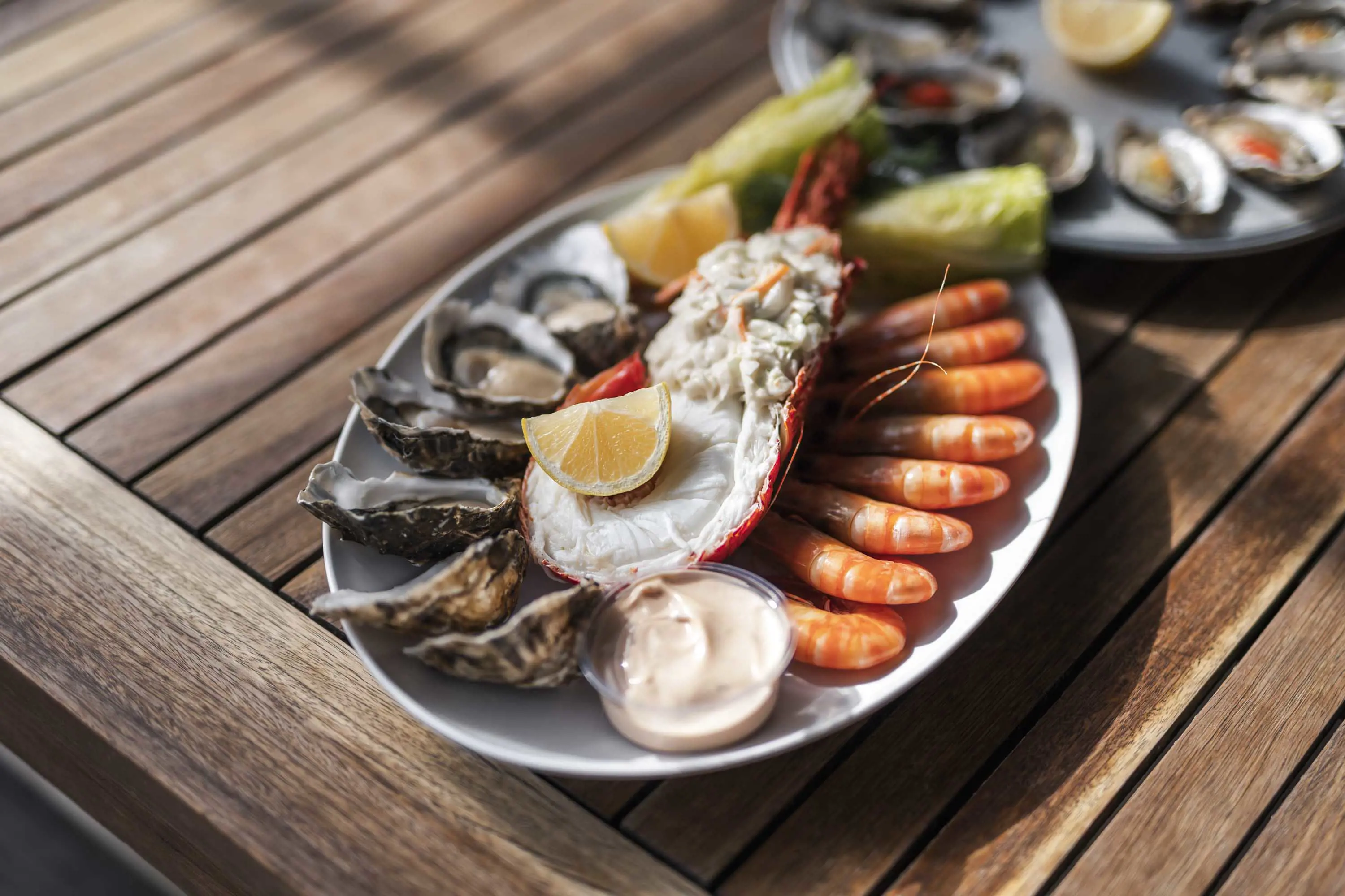 A seafood platter of prawns, oysters, half a crayfish and dips.