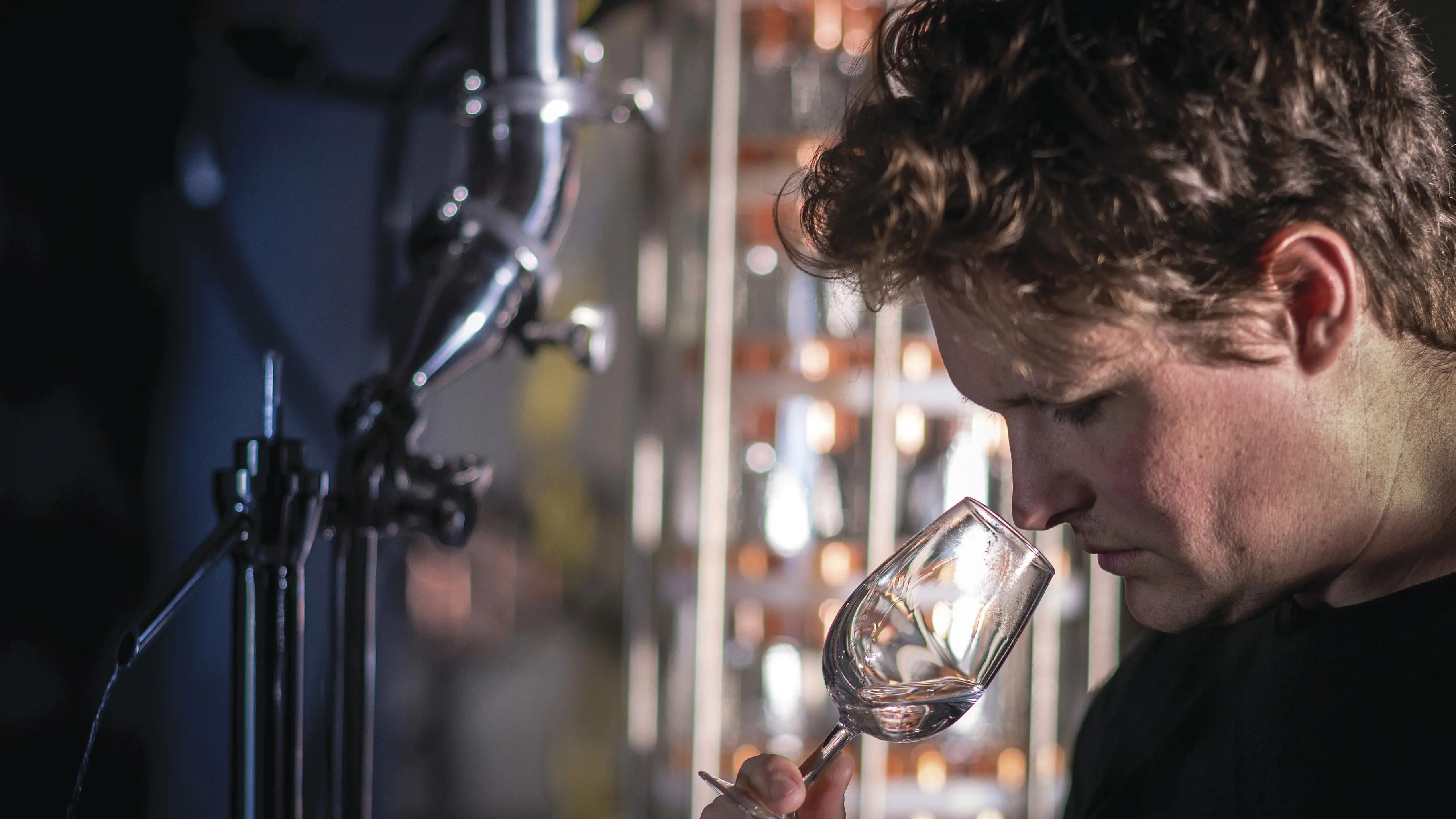 Close up of someone smelling spirits in a glass at Hartshorn Distillery, where Vodka and Gin is made from sheep whey.