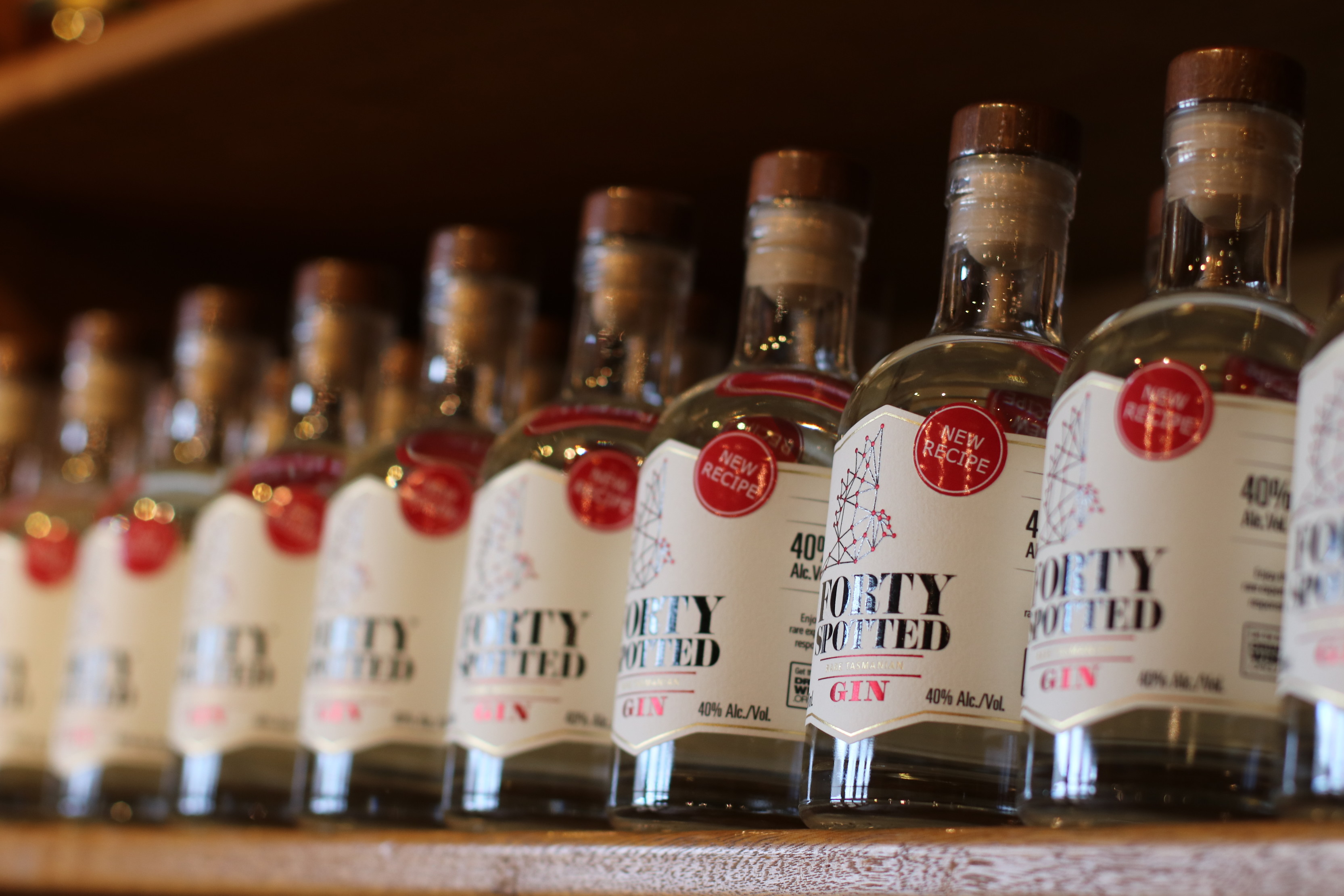 Close up of bottles of Forty Spotted Rare Tasmanian Gin by Lark Distillery, lined up on a shelf.