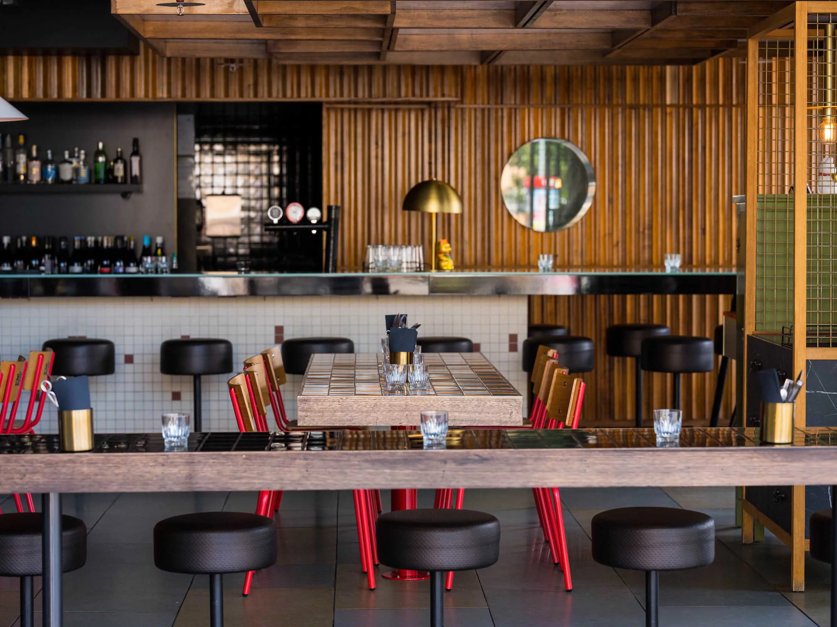 A contemporary restaurant decorated with wood paneling and tiled surfaces. 