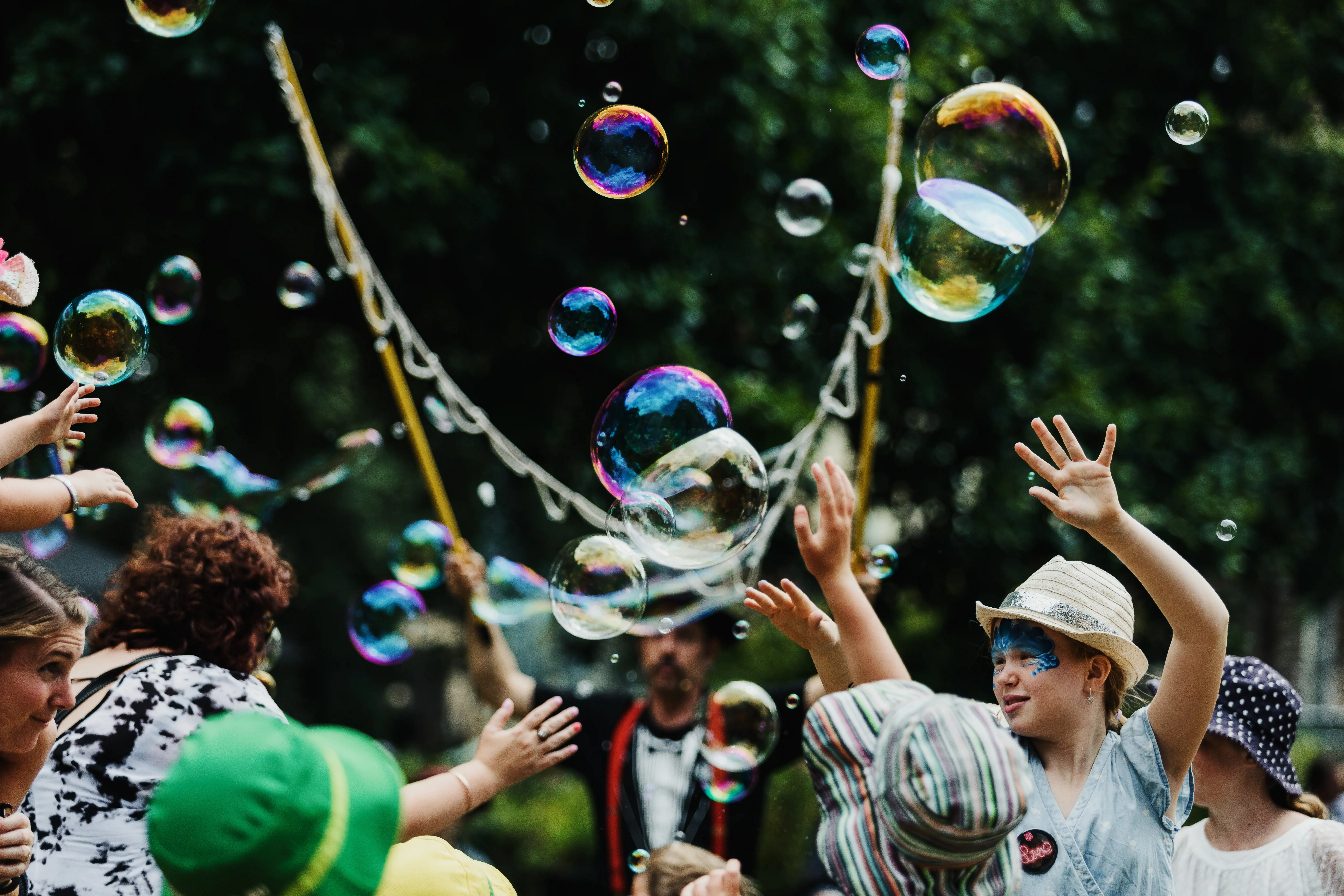 A group of festival goers dance amongst bubbles in the park as part of Launceston's Festivale.