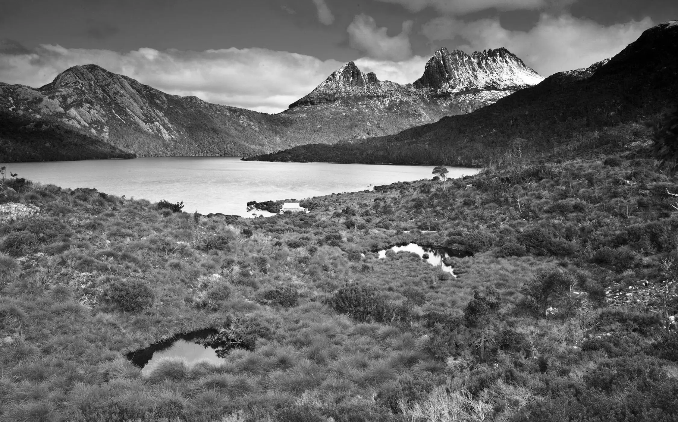 The alpine landscape of Dove Lake, with Cradle Mountain dusted in snow rising up beyond.