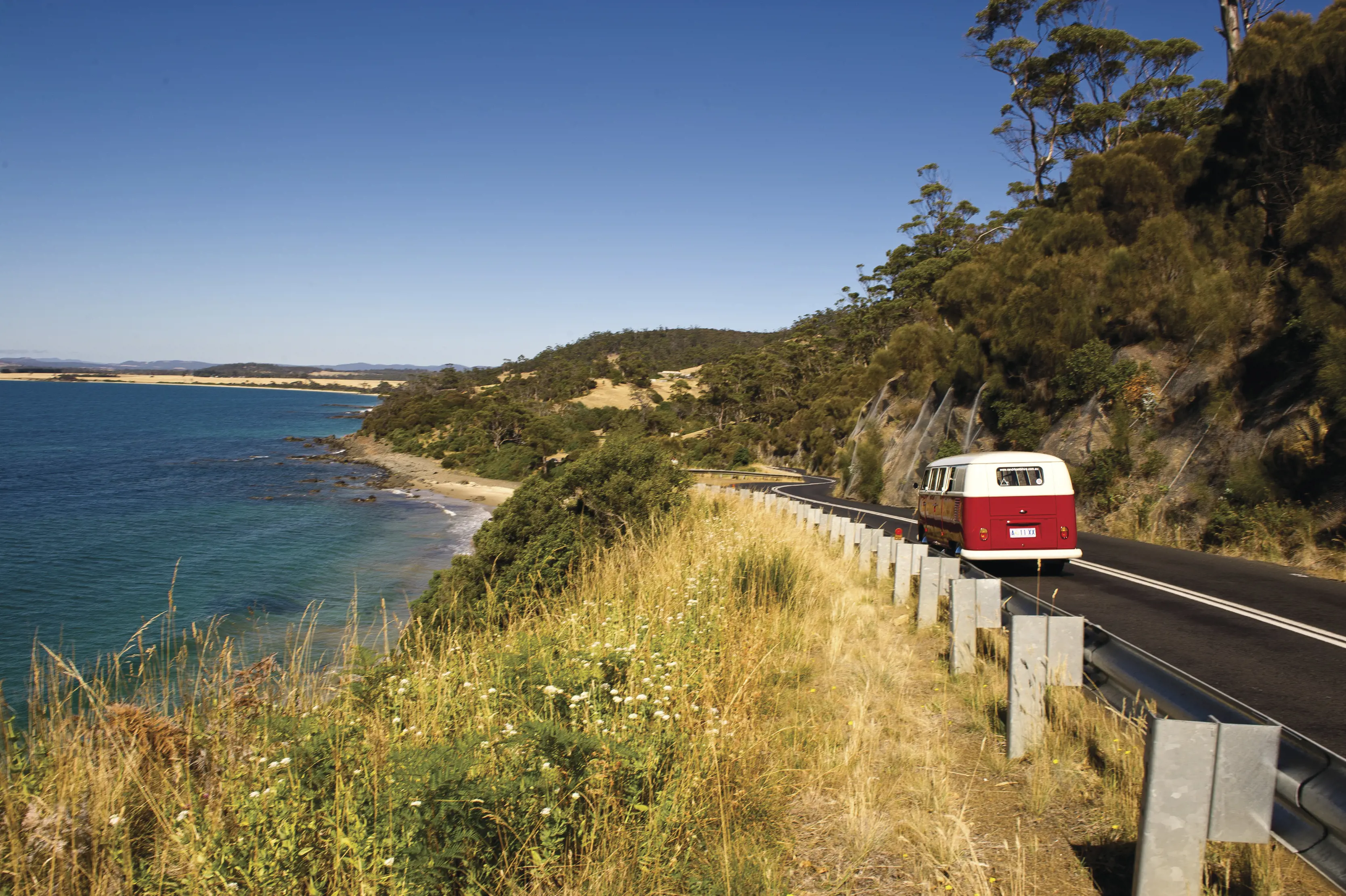 A campervan touring past Swansea Coastline, on Tasman Highway.