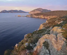 Birds eye view over Sleepy Bay, Freycinet Peninsula. Ocean view on the left, up against the mountain cliffs on the right. 