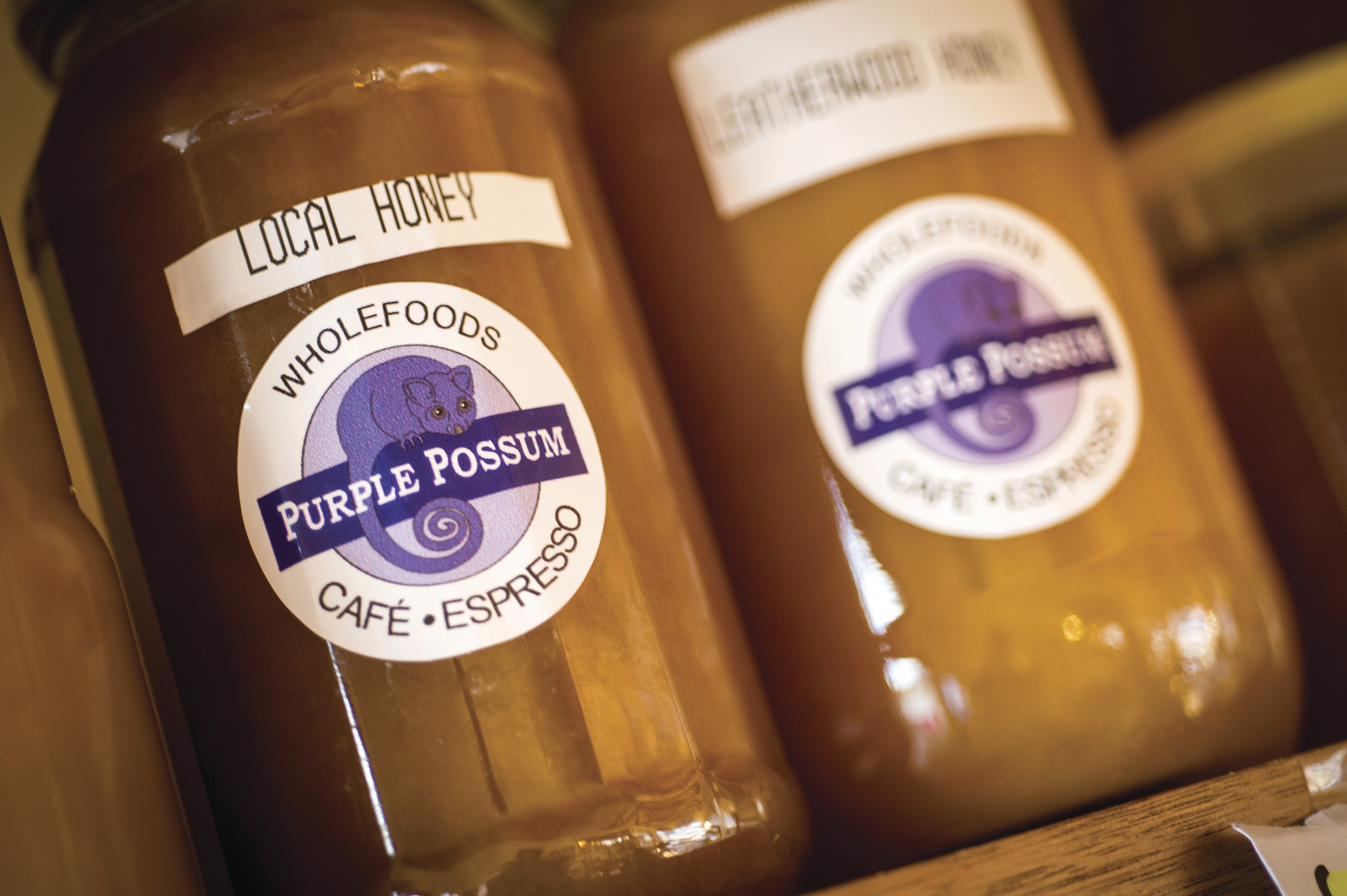 Two bottles of local honey. Called 'purple possum'. From the purple house cafe in St Mary's.