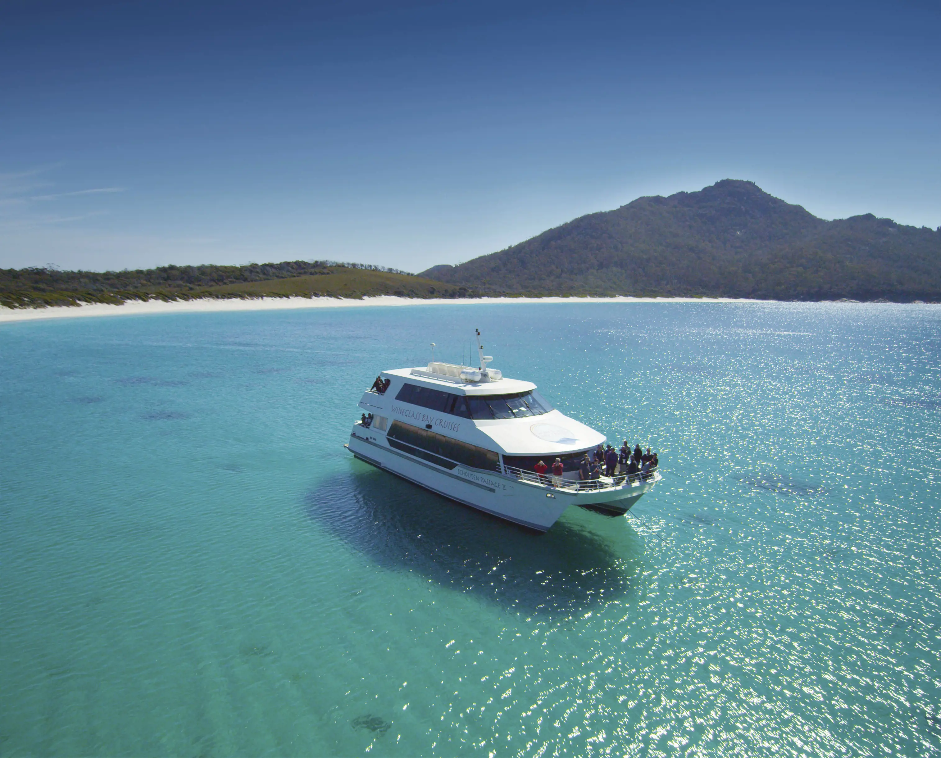 Yacht floating on clear blue waters in Wineglass BAy