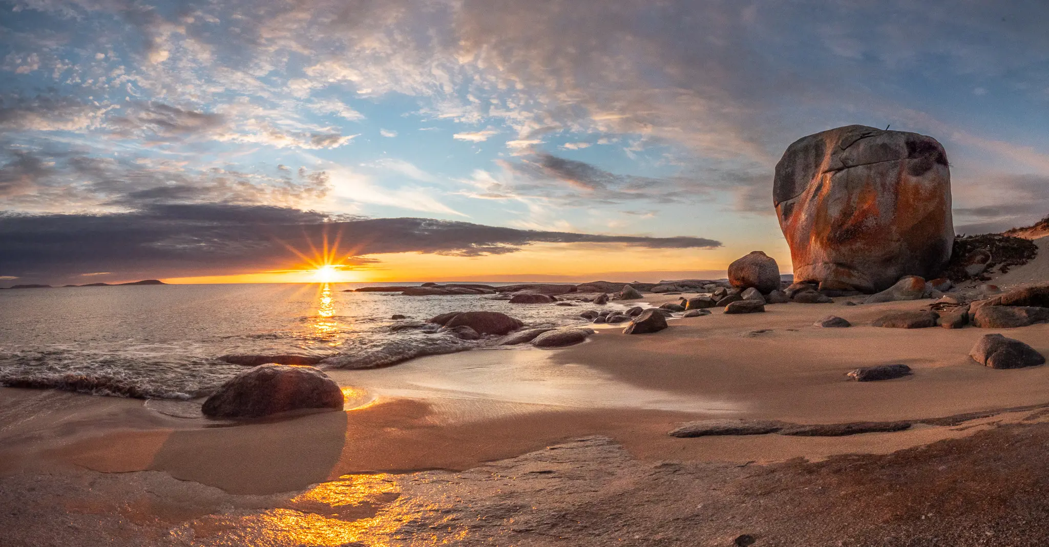 The sun sets over the sea at Castle Rock, Flinders Island