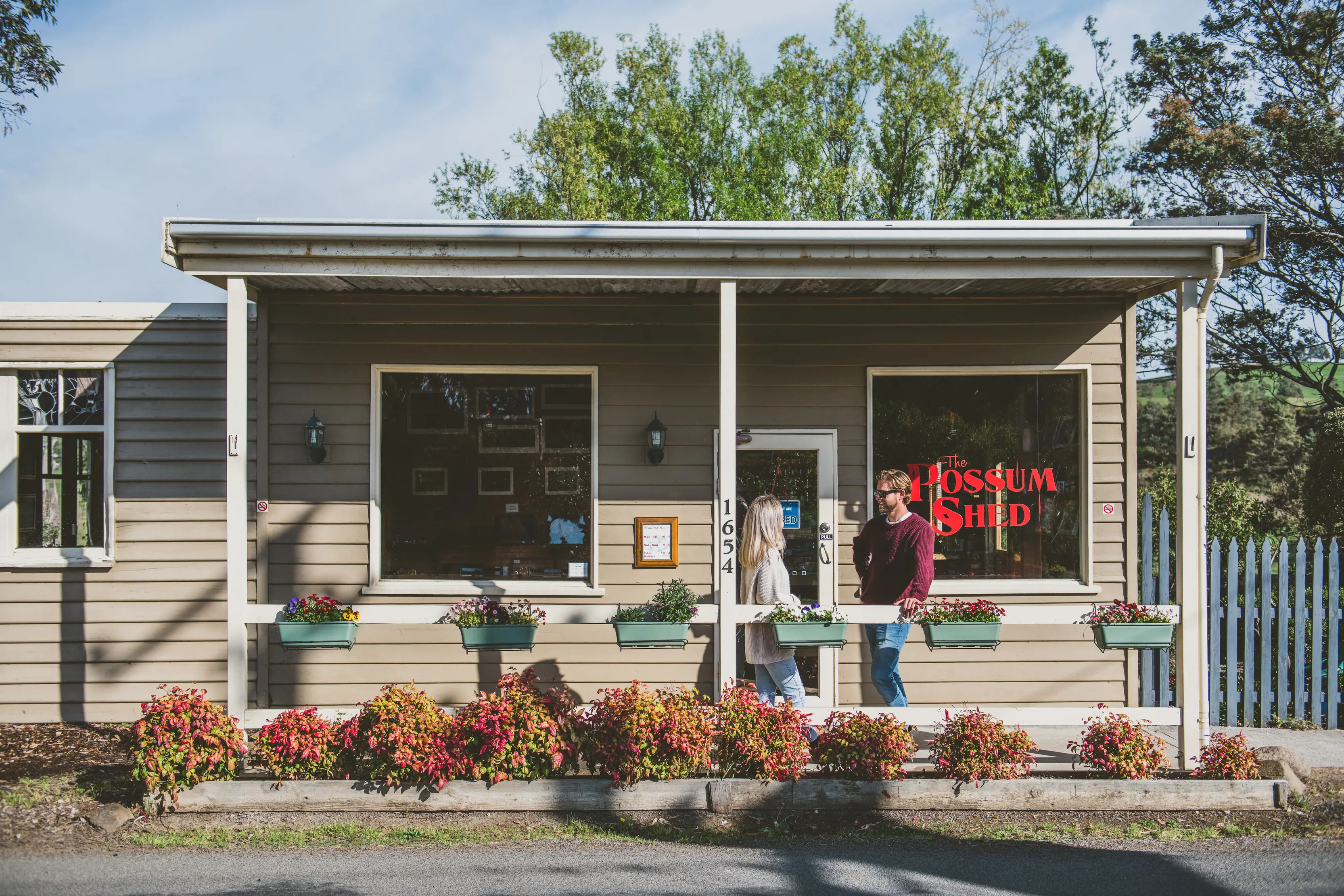 Image of a couple standing outside The Possum Shed, an ideal shop offering lunches made with fresh Tasmanian produce.