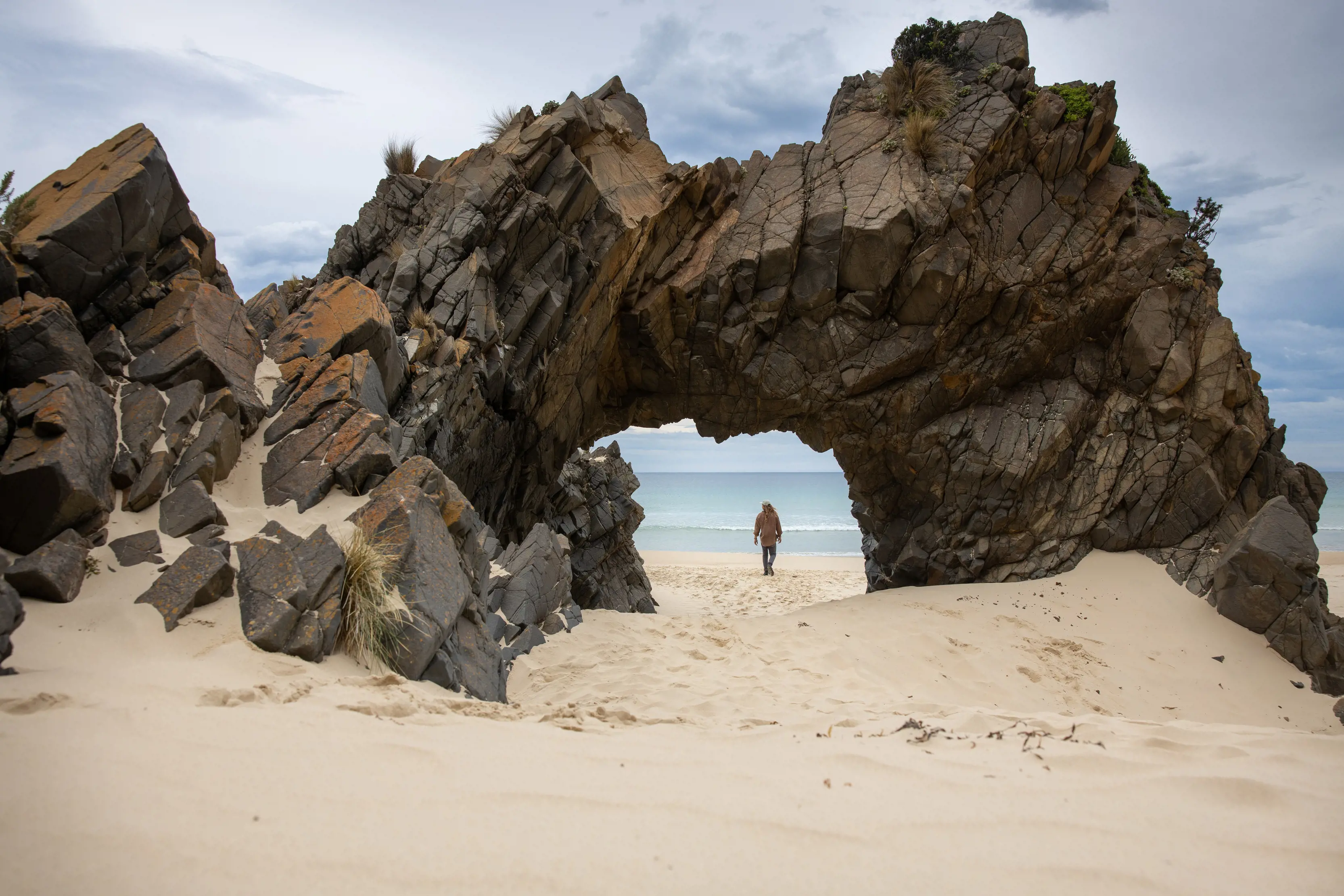 "An incredible image of a person under the the rocky archway in the sand at Mars Bluff. "