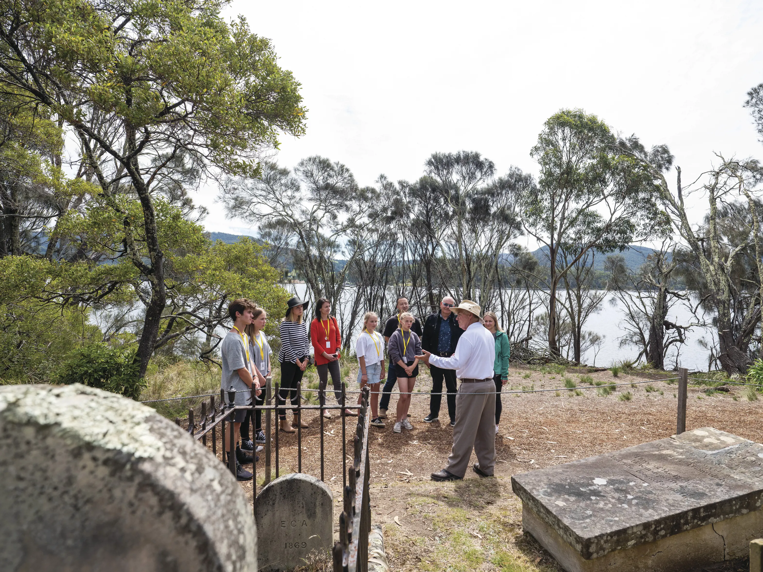 Tour guide with tourists around the graveyard of the Isle of the Dead - Port Arthur Historic Site.