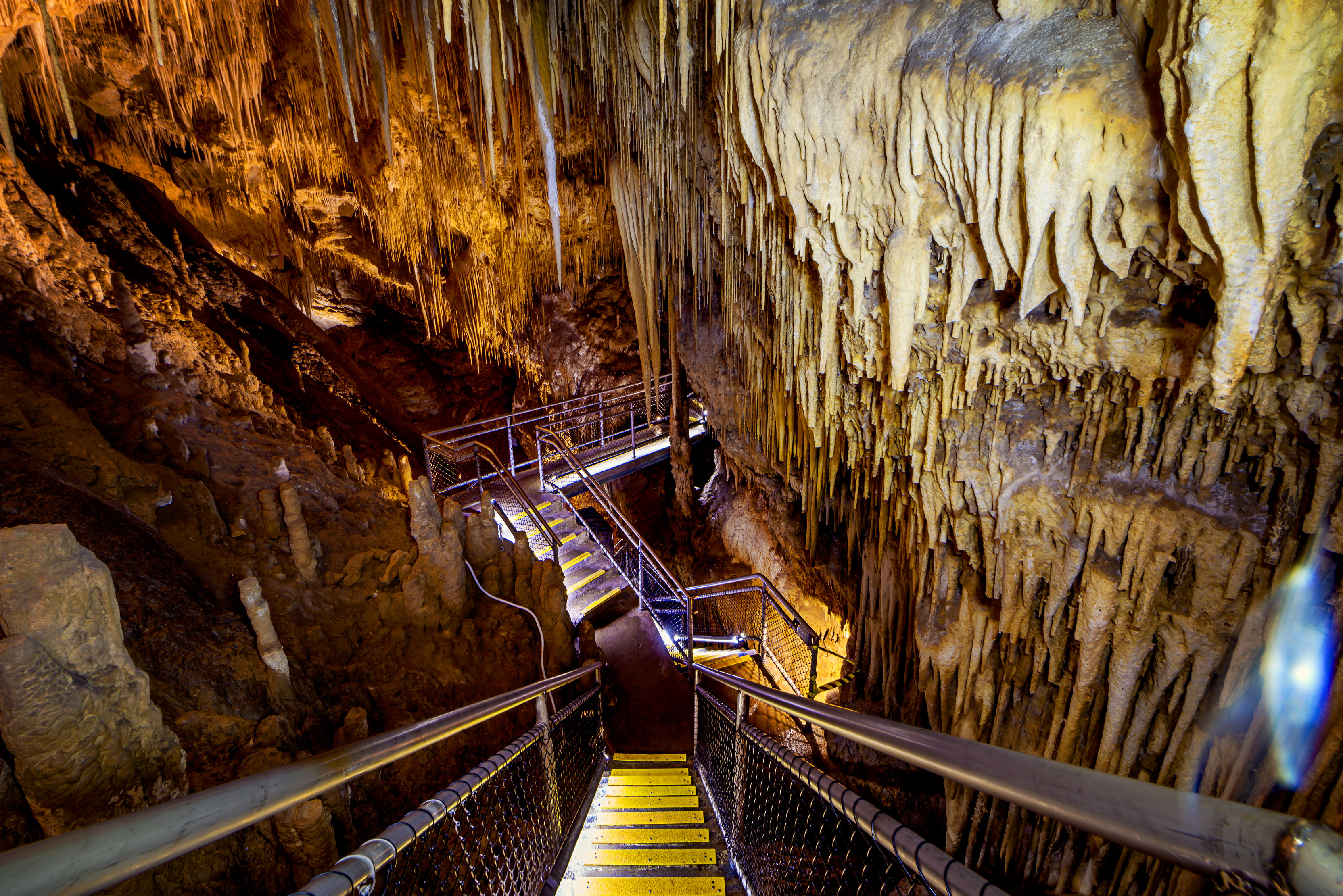 Looking down a steep stair walk into the caverns of the dolomite cave at Hastings Caves and Thermal Springs in the Huon Valley.