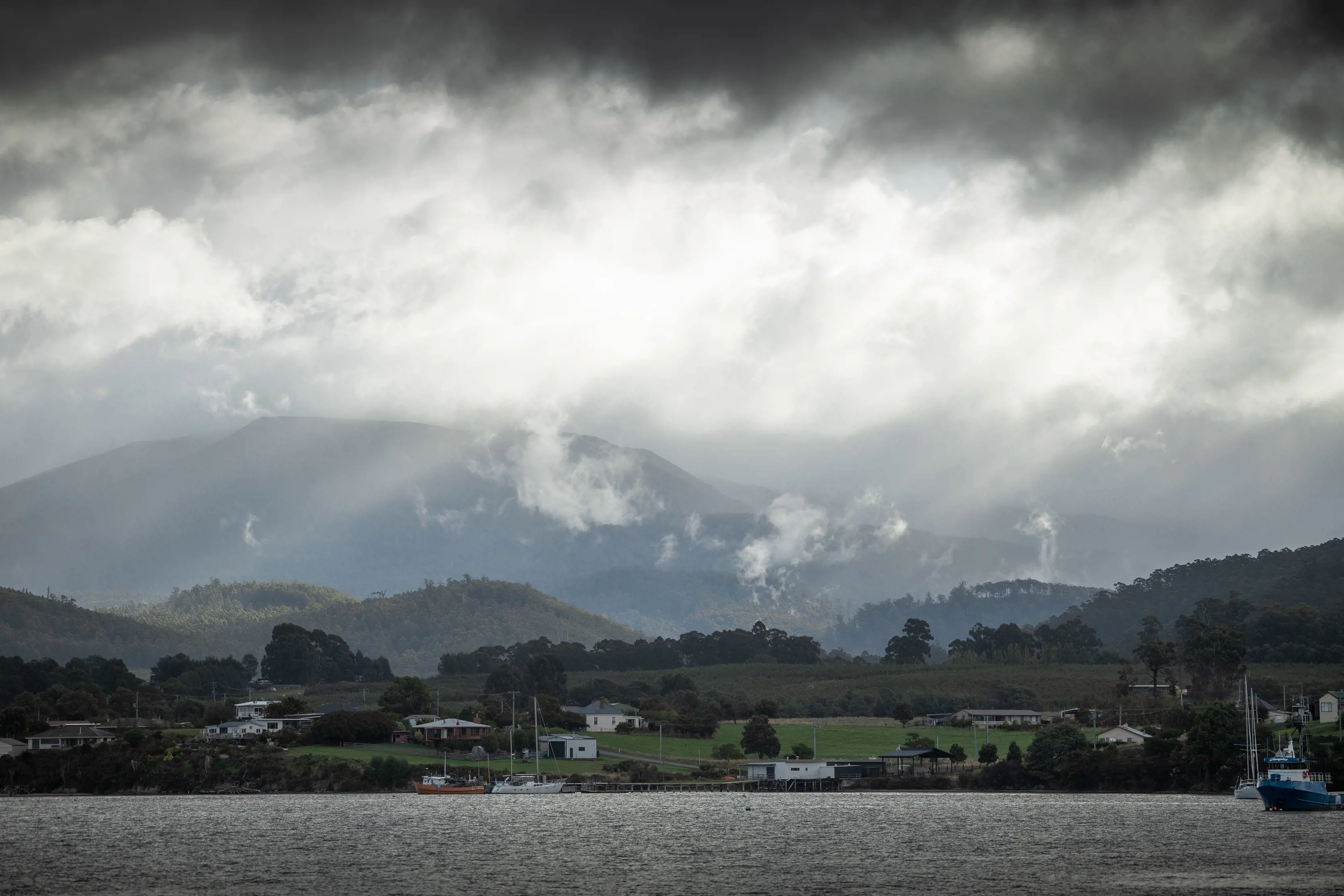 Dark grey clouds pass over Dover, a small fishing village.