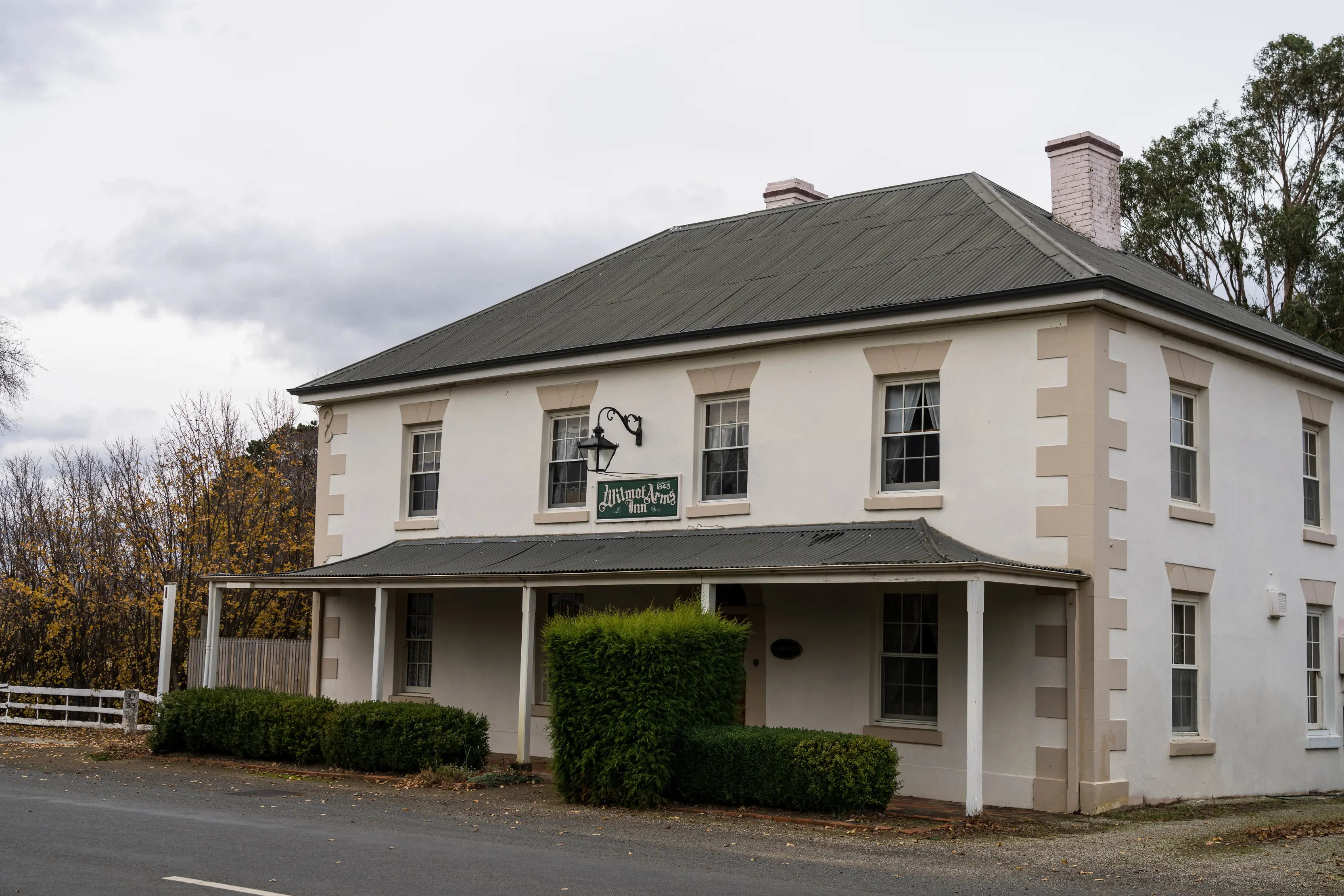 Exterior of Wilmot Arms Inn, clouds in the backdrop.