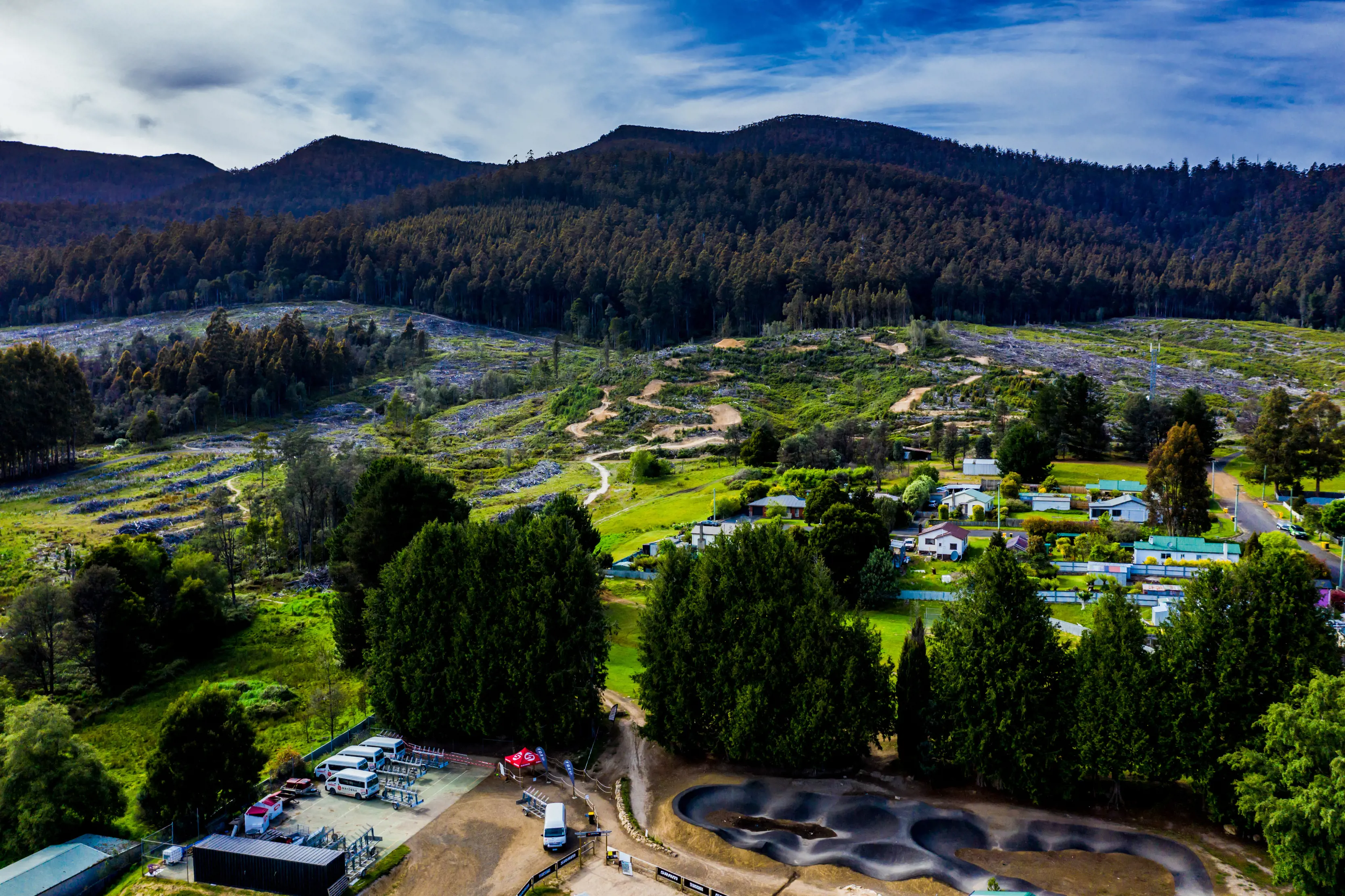 Stunning view of Maydena Bike Park. Surrounded by mountains, grassy roads, treet and farmland. 