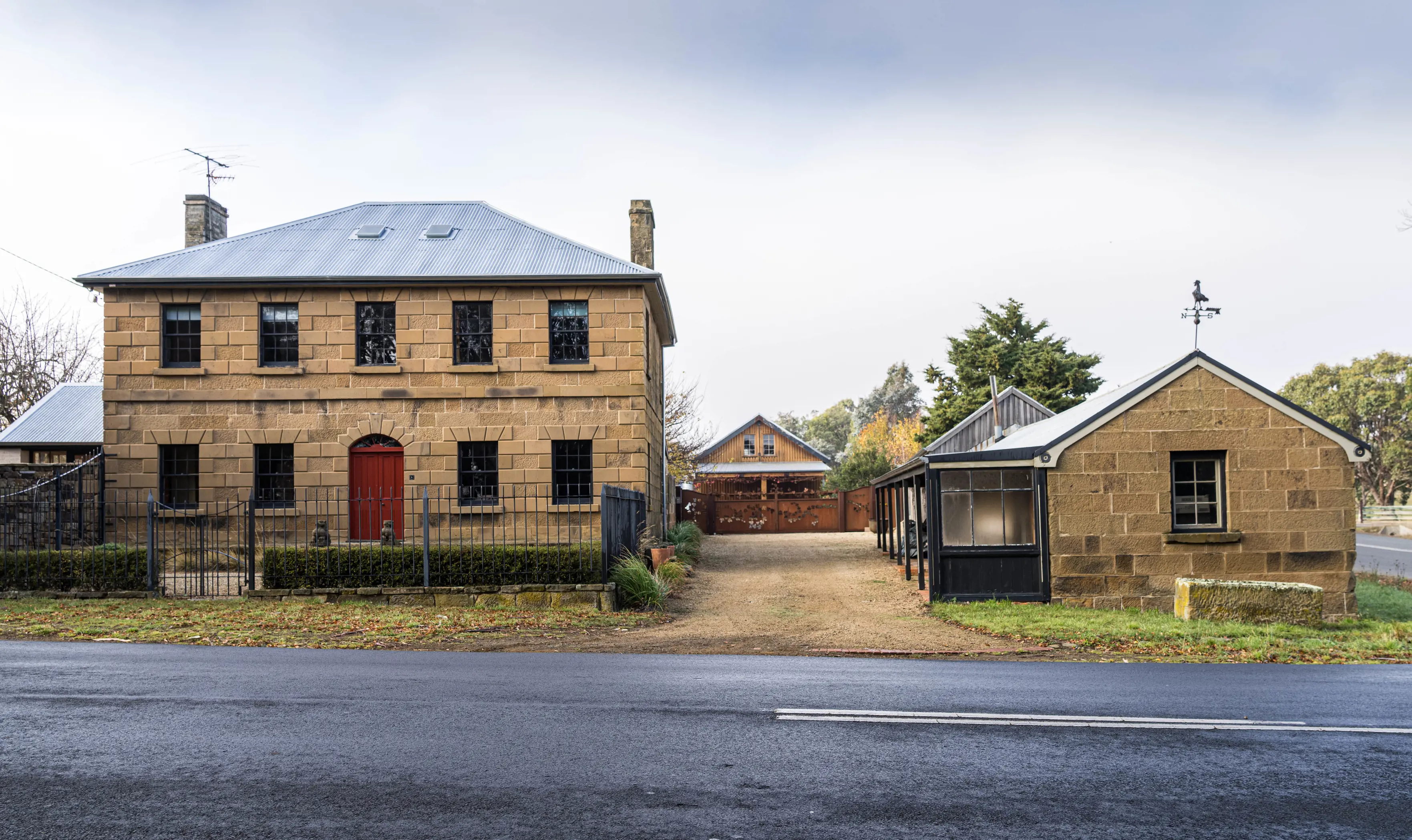 Stunning sandstone mansion with red door. Historic house and old Barn, Oatlands