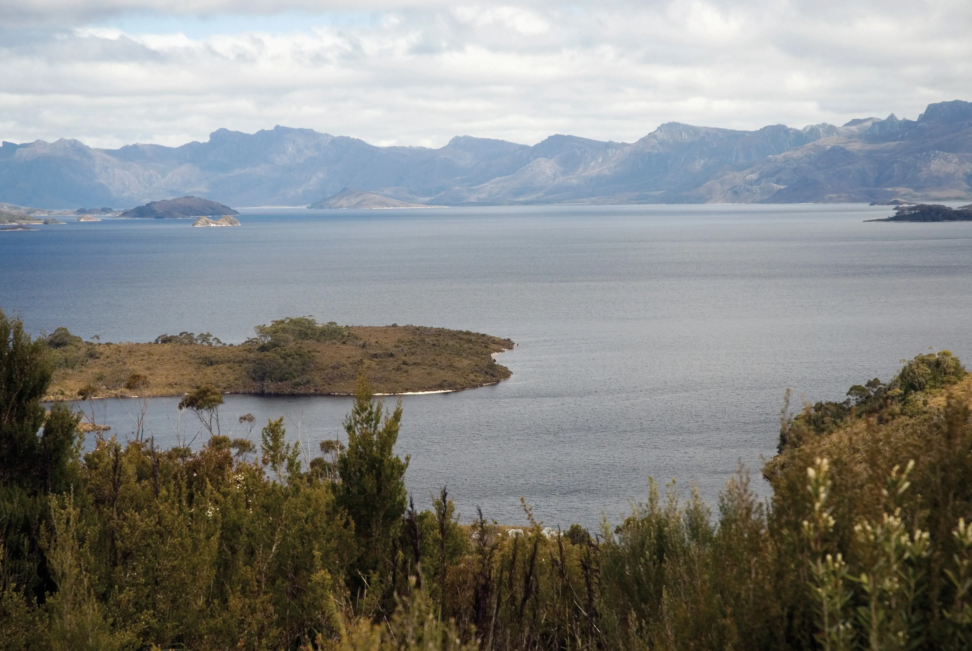 Landscape view of Lake Pedder, with mountains in the backdrop.