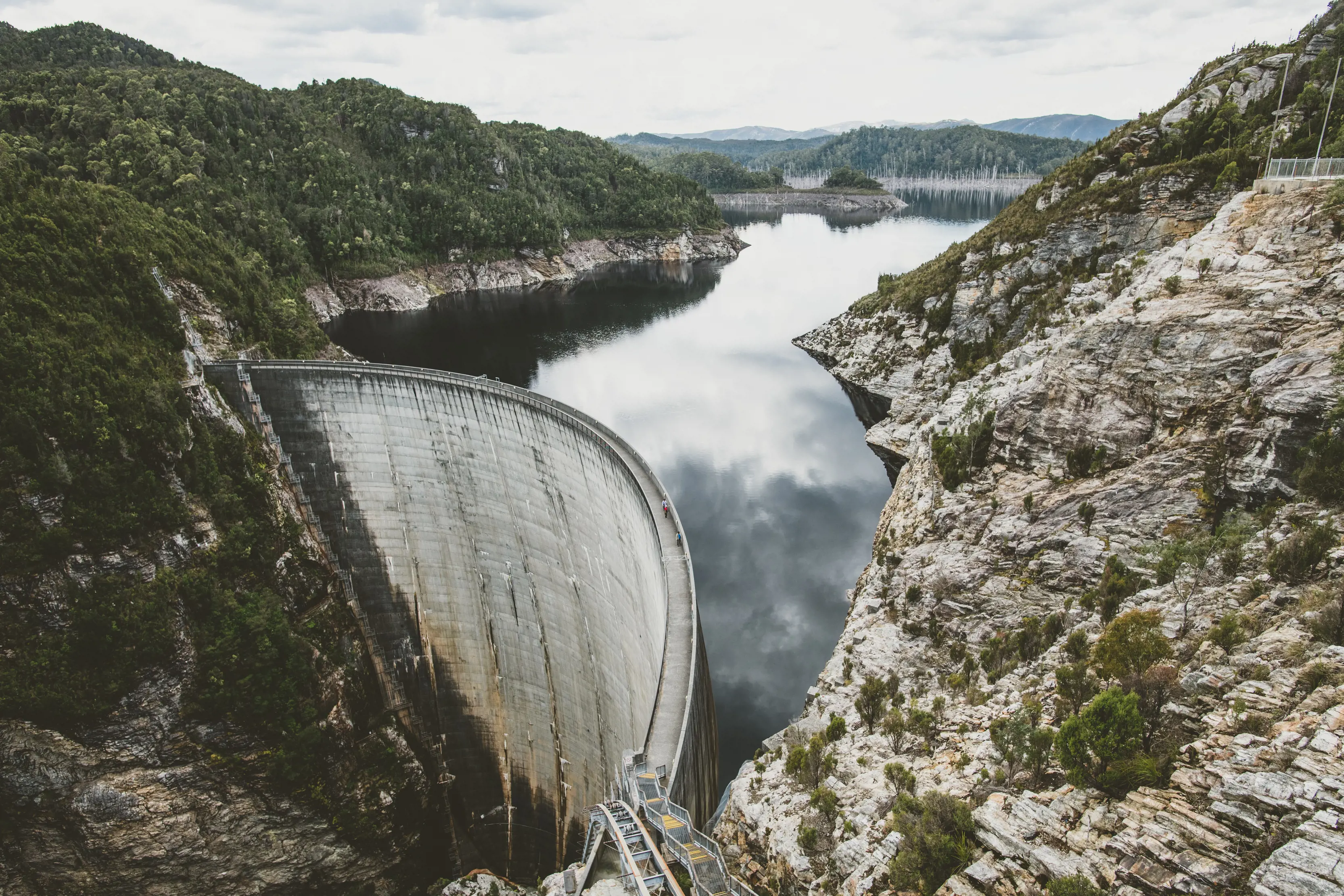 Landscape image of the Gordon Dam, a double curvature arch dam on the Gordon River.