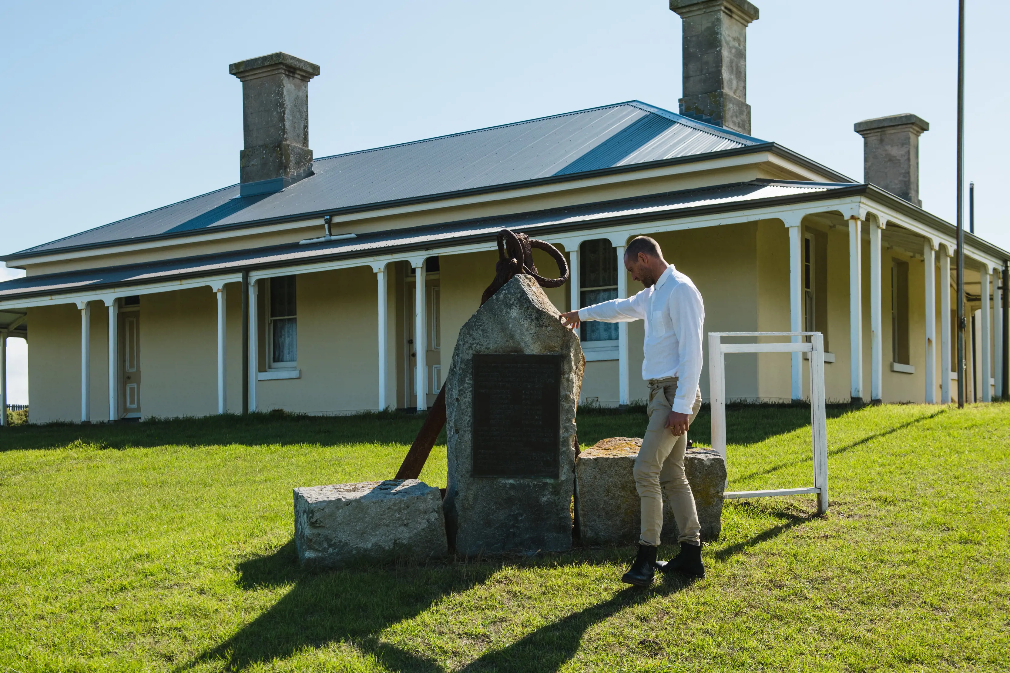 A traveller reads a sign on a monument outside the former lighthouse keeper’s residence at King Island Museum.