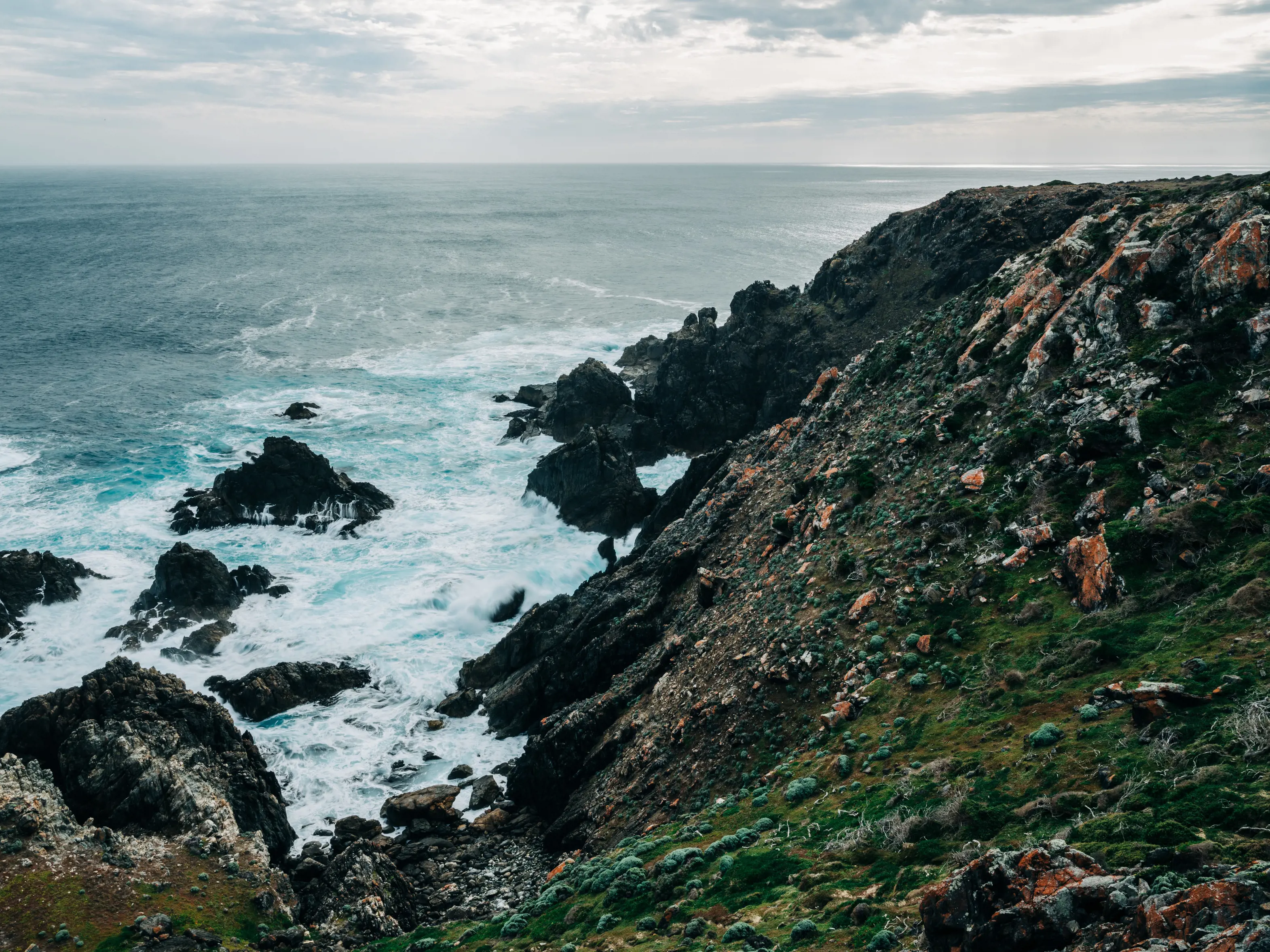 Water crushing the side of a rocky edge at Seal Rocks, King Island. 