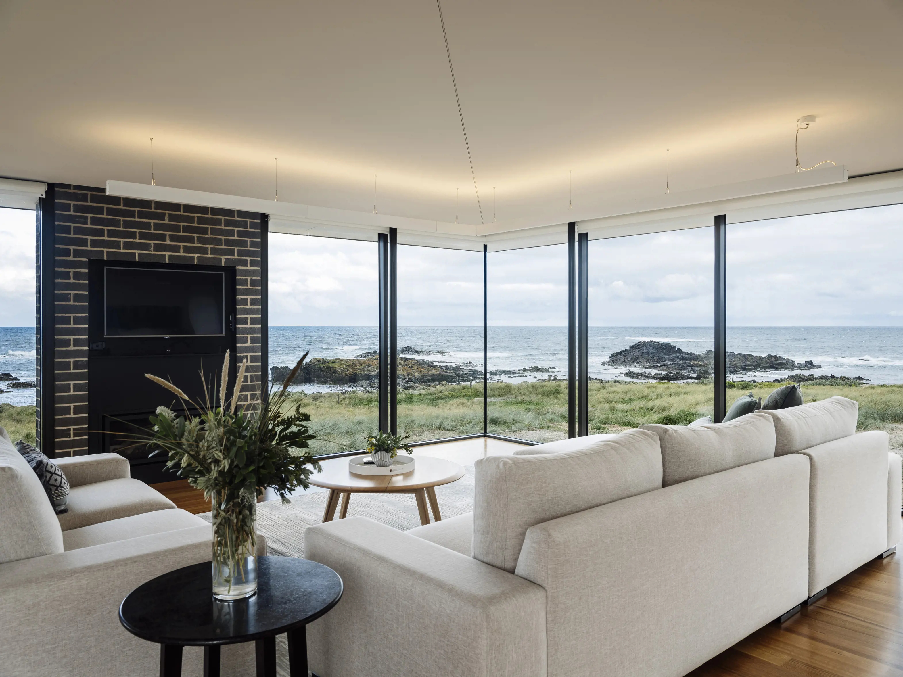 Image of incredible interior of one of three fully glazed luxury coastal retreats looks out to the amazing coastline, located in Ettrick Rocks.