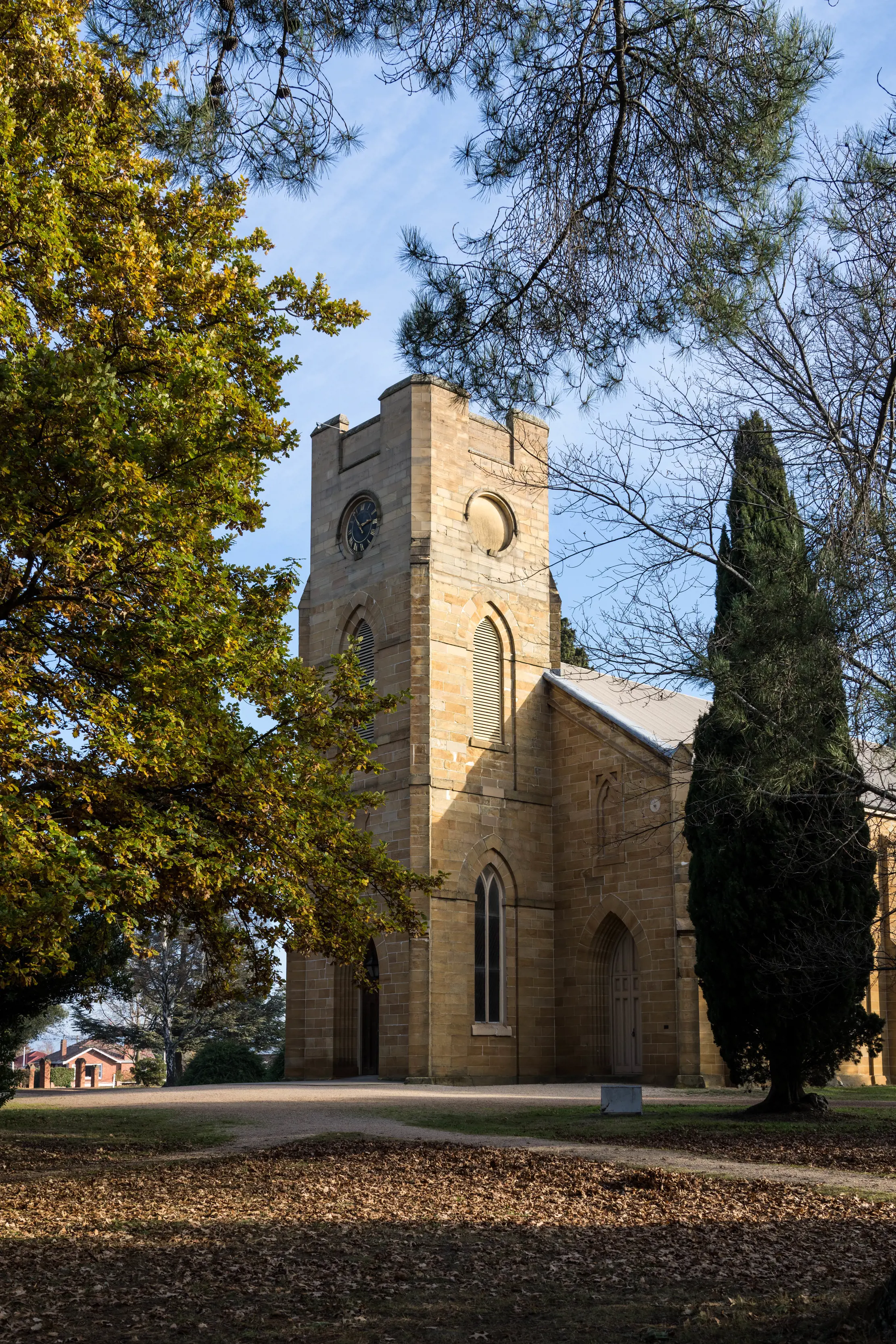 Exterior of Christ Church Anglican Church, Autumn leaves are on the floor in the foreground.