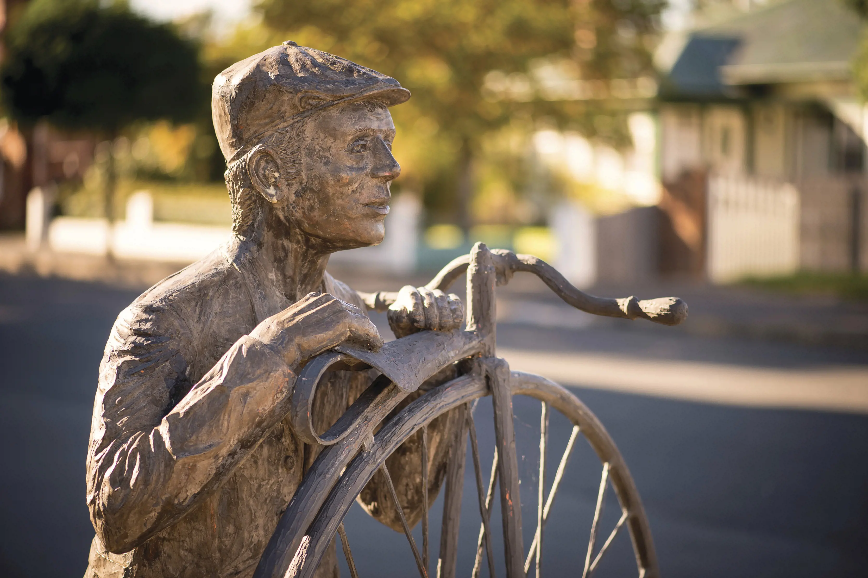 Streetscape at Evandale, with a historical statue of a male in the foreground.