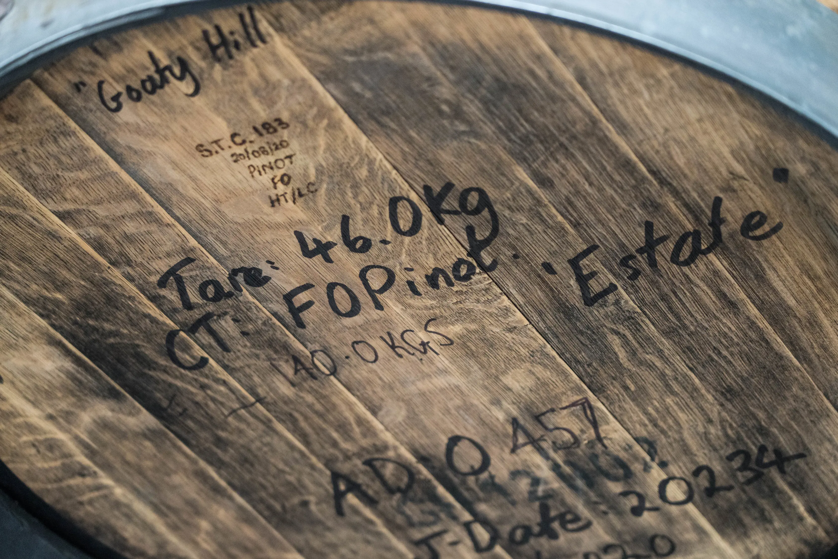 Product information include weights and dates are noted on a barrel at Adams Distillery.