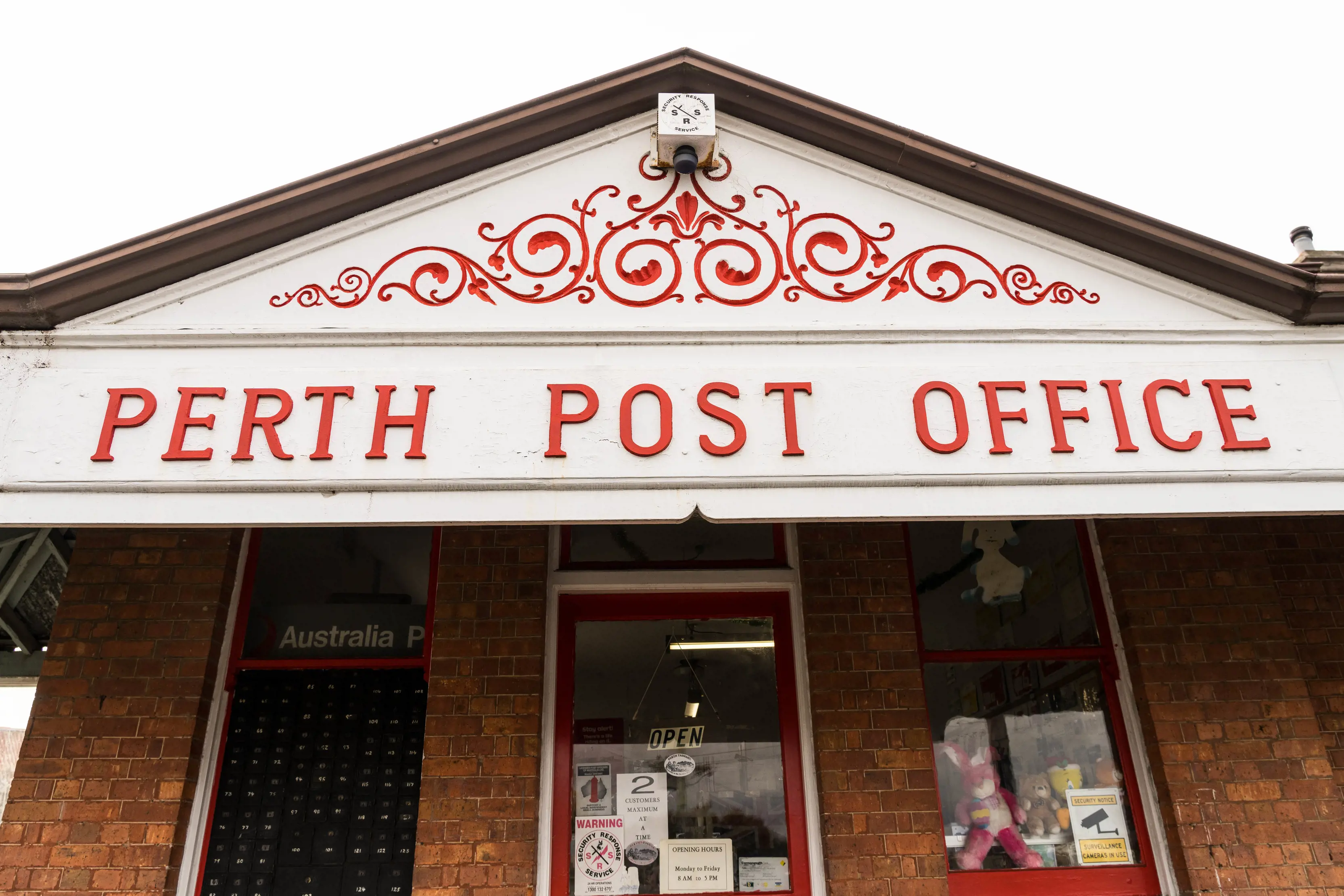 Exterior of the red Perth Post Office sign.