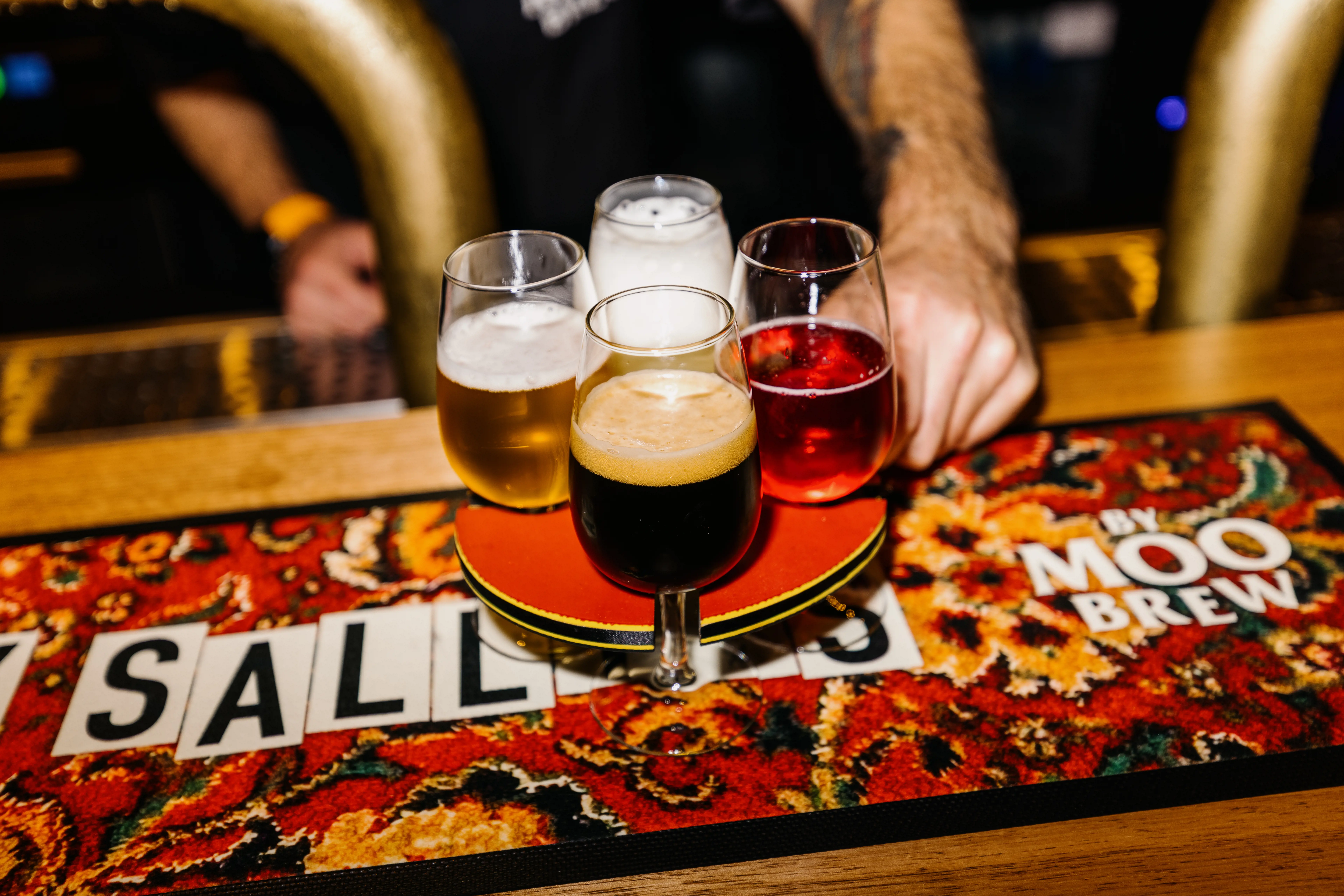 Variety of beers served over a colourful bar mat