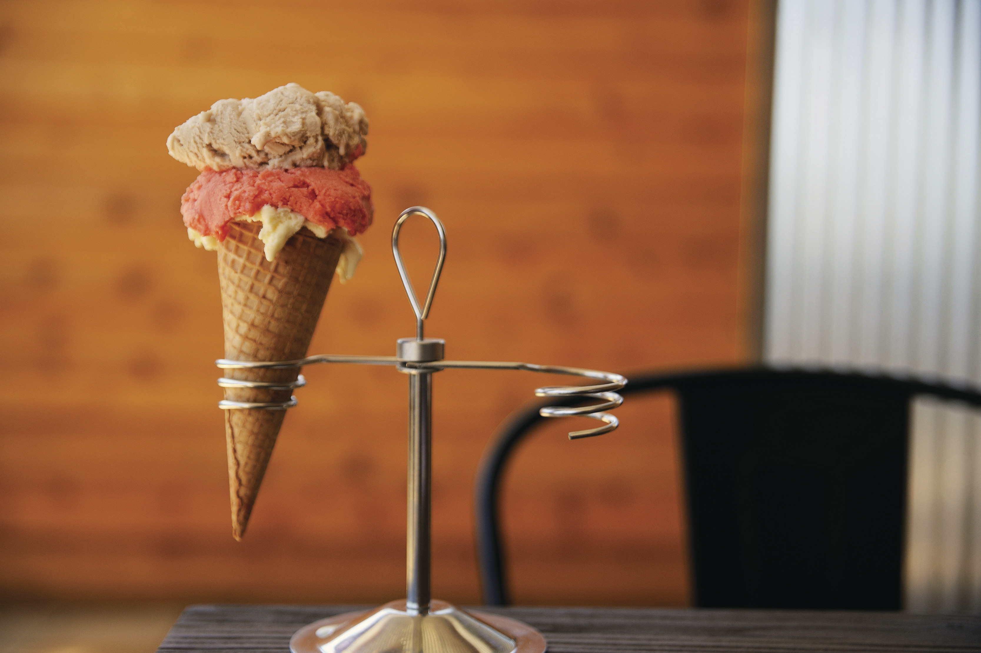 Close up of a cone of ice cream with 3 different flavour scoops at Van Diemens Land Creamery Cafe.