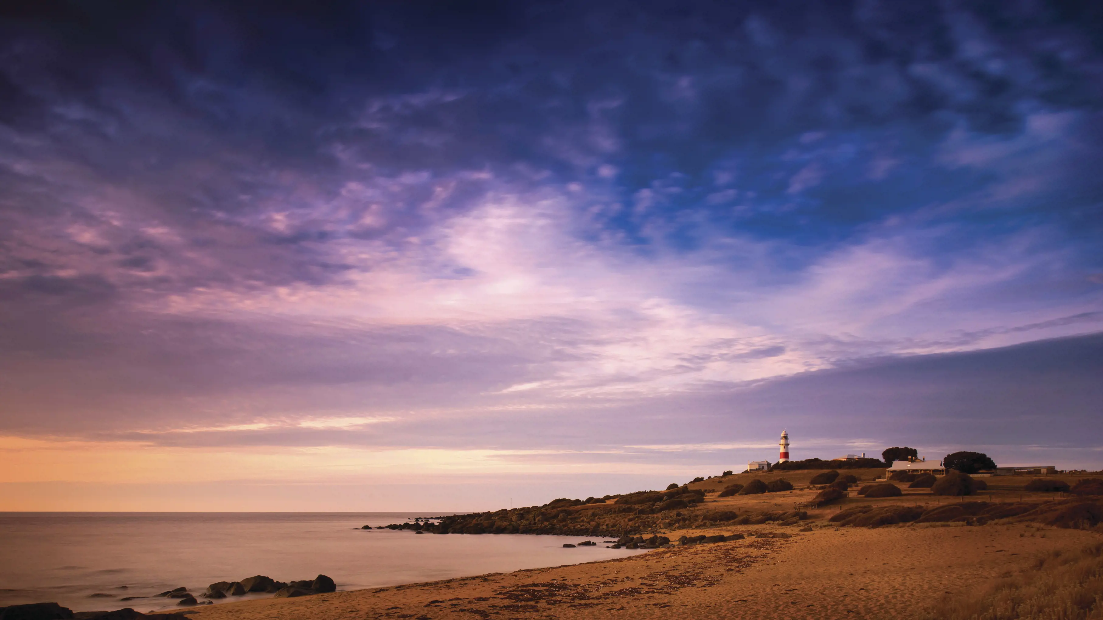 Purple skies over Low Head, on a peninsula at the mouth of kanamaluka / River Tamar, with the lighthouse in the distance.
