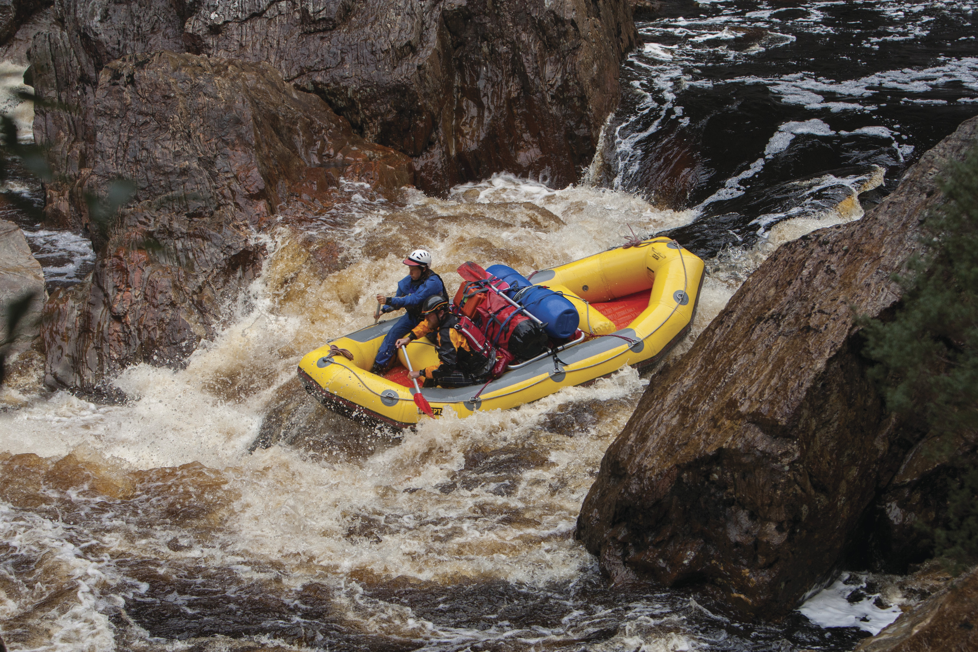 Intense image of two people white water rafting in rough waters on the Franklin River.