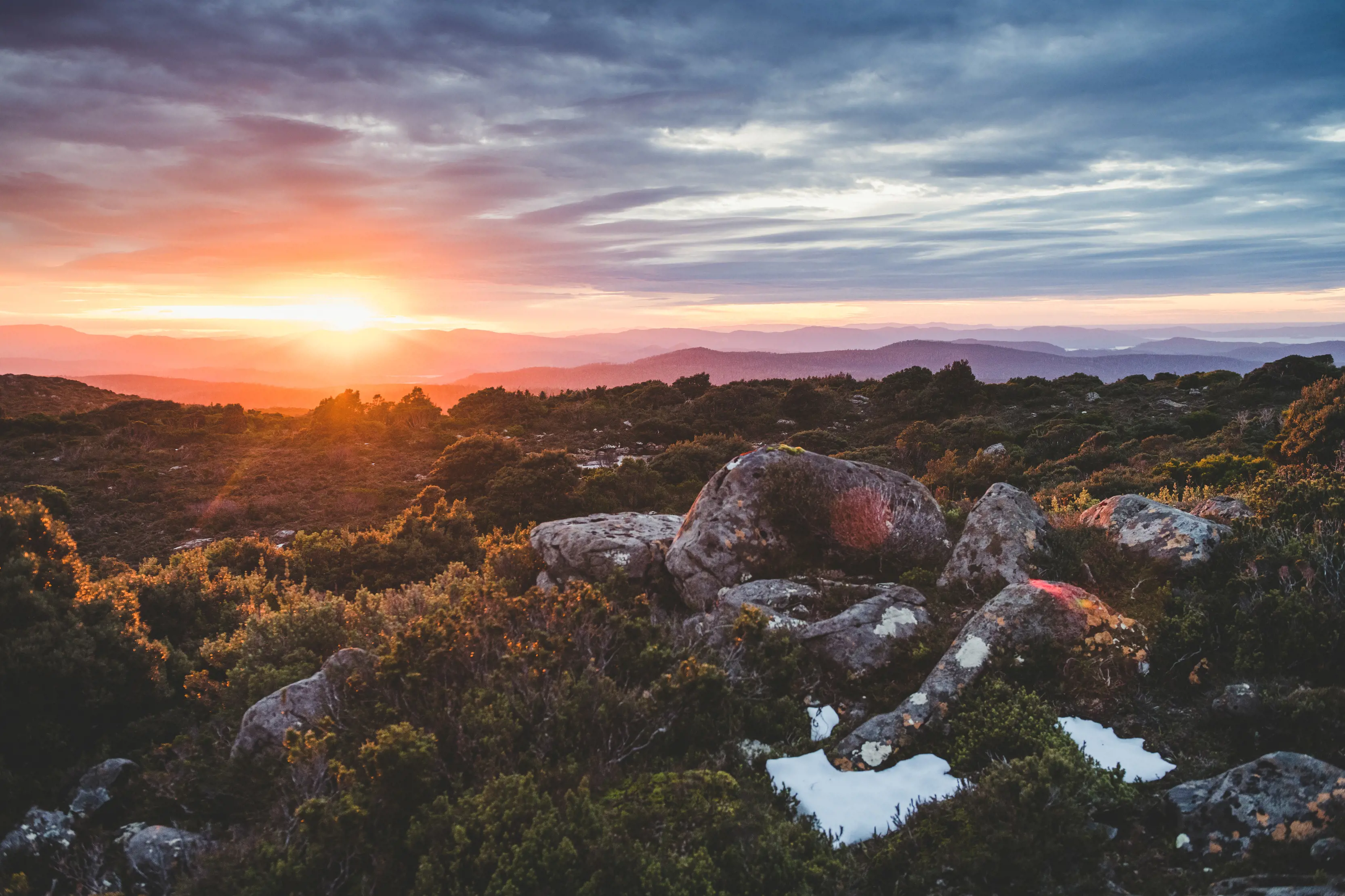 Spectacular image during a vibrant sunrise, of the landscape on Hartz Peak Walk, Hartz Mountains National Park. Surrounded by lush greenery.