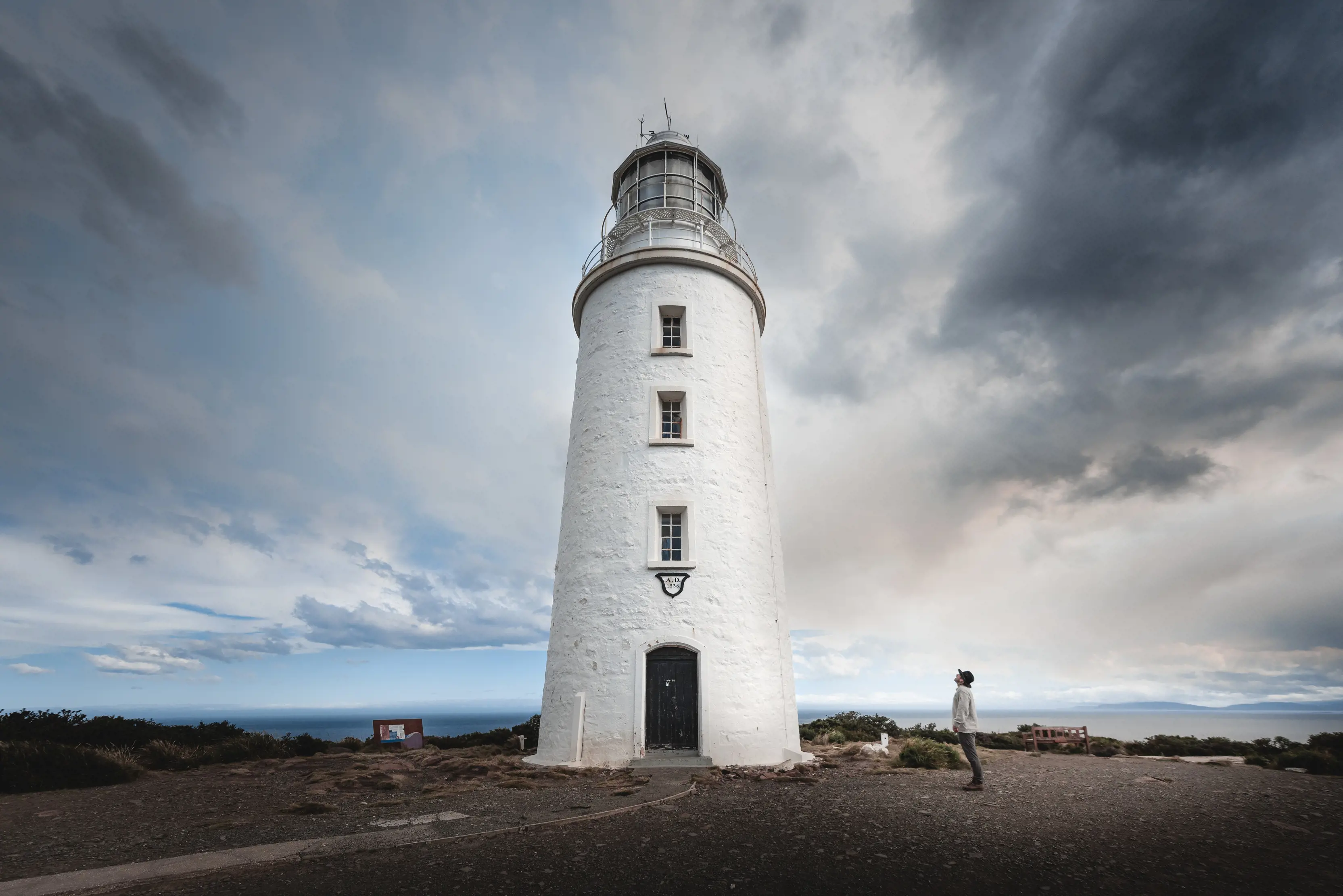 Dramatic wide angle view of a person looking up at the Cape Bruny Lighthouse.