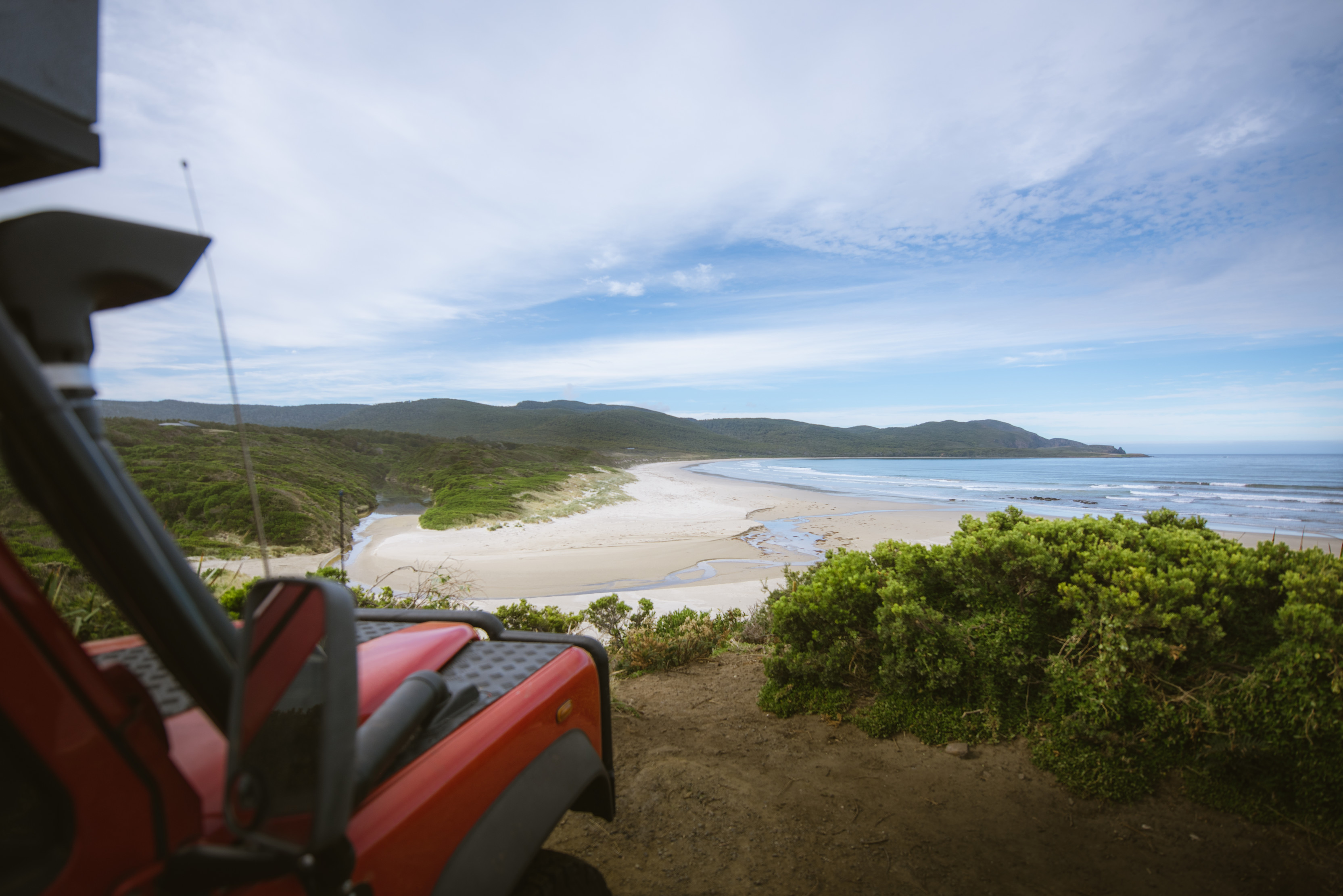 Car parked at the top of Cloudy Bay, South Bruny National Park, overlooking the stunning landscape and ocean.