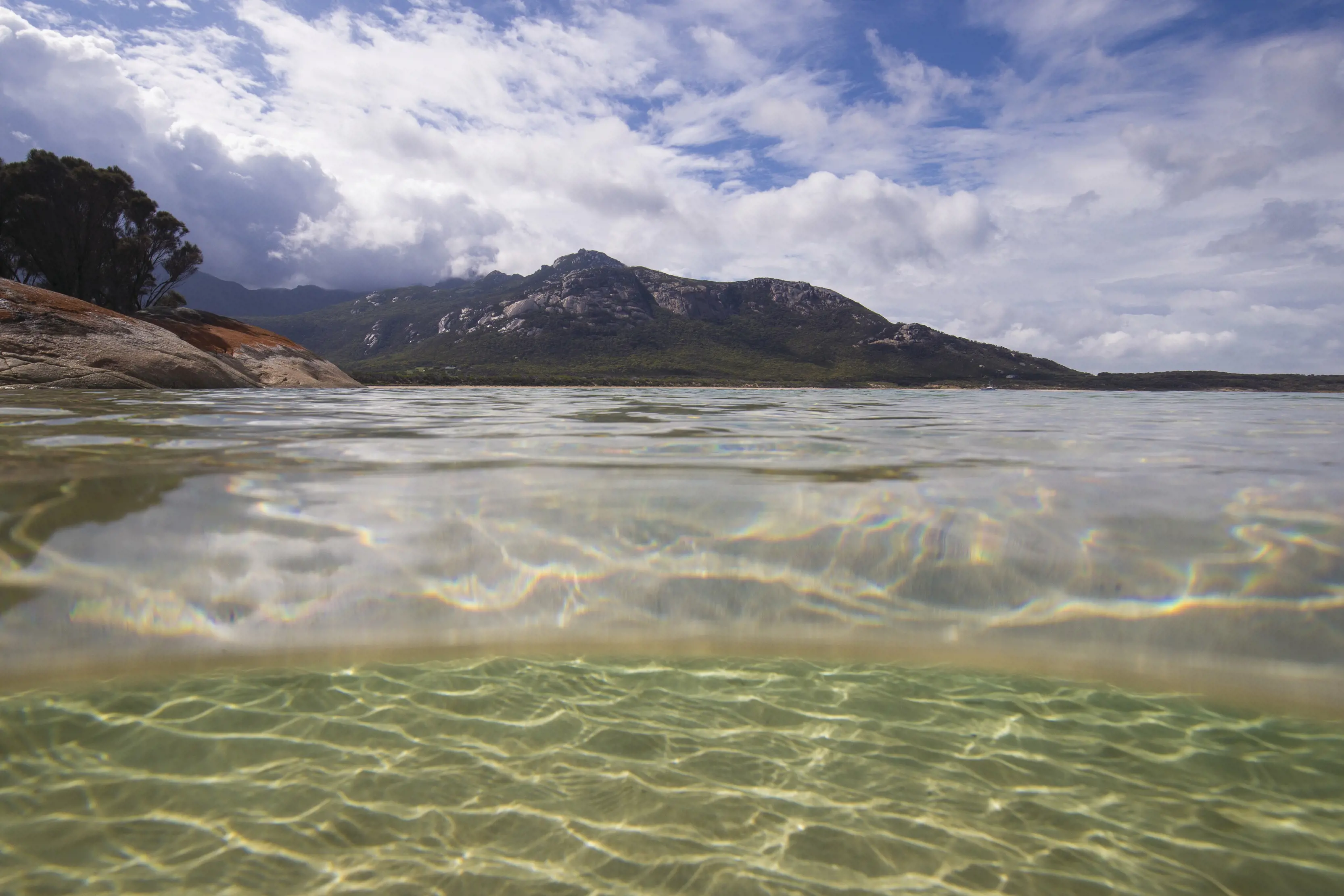 Stunning over-under image taken in the ocean of Mt Strzelecki from Trousers Point.