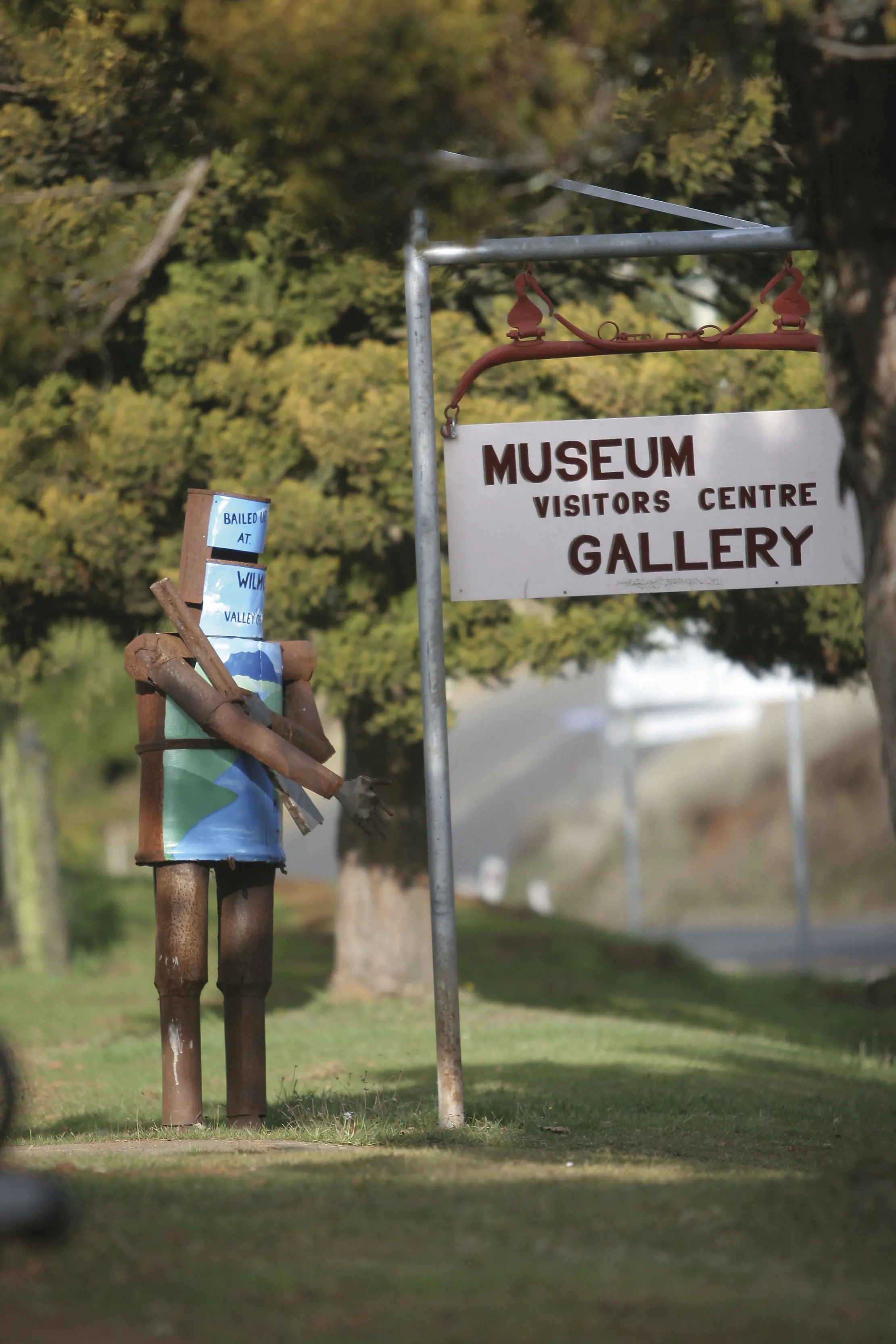 Wilmot novelty letterbox trail - A bushranger and a sign to the Museum, Gallery and visitors centre. 