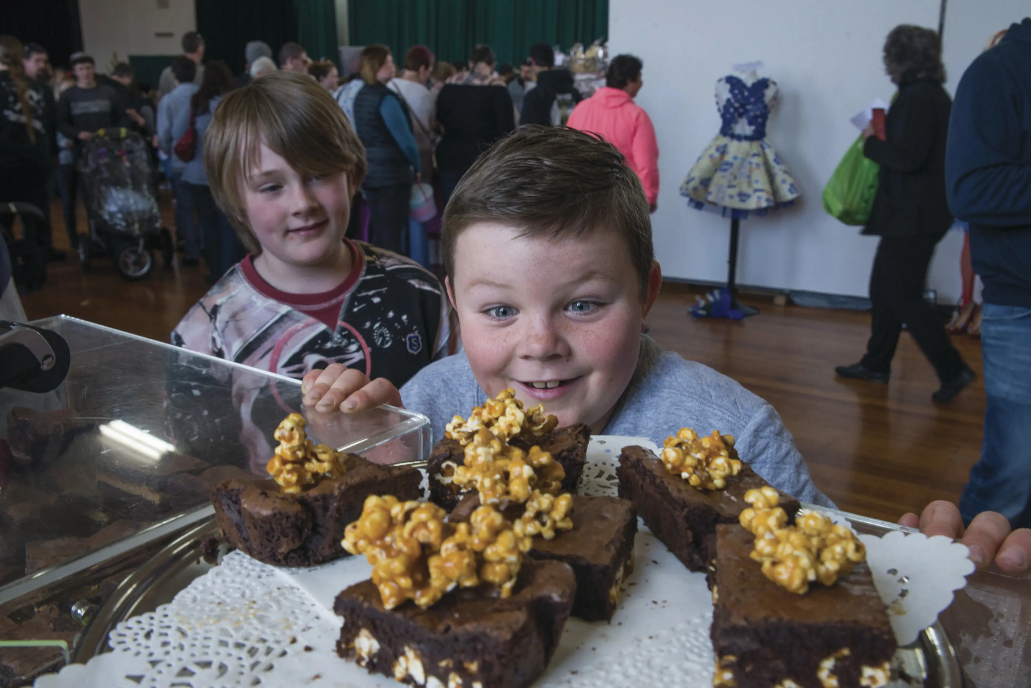 Close up image of a small boy and his friend, mouthwatering over chocolate at the Chocolate Winterfest.
