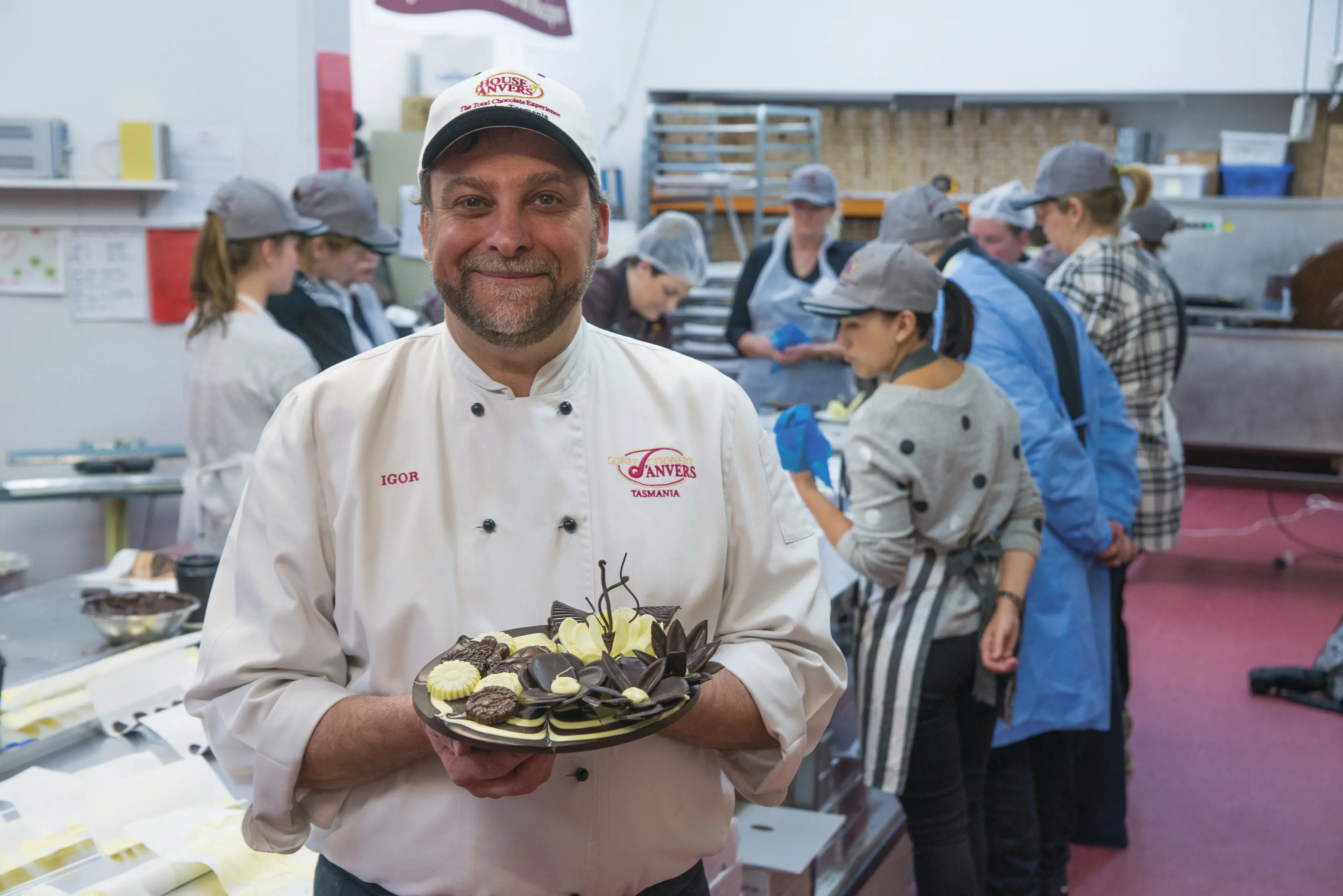 Chef holding food made at the House of Anvers.