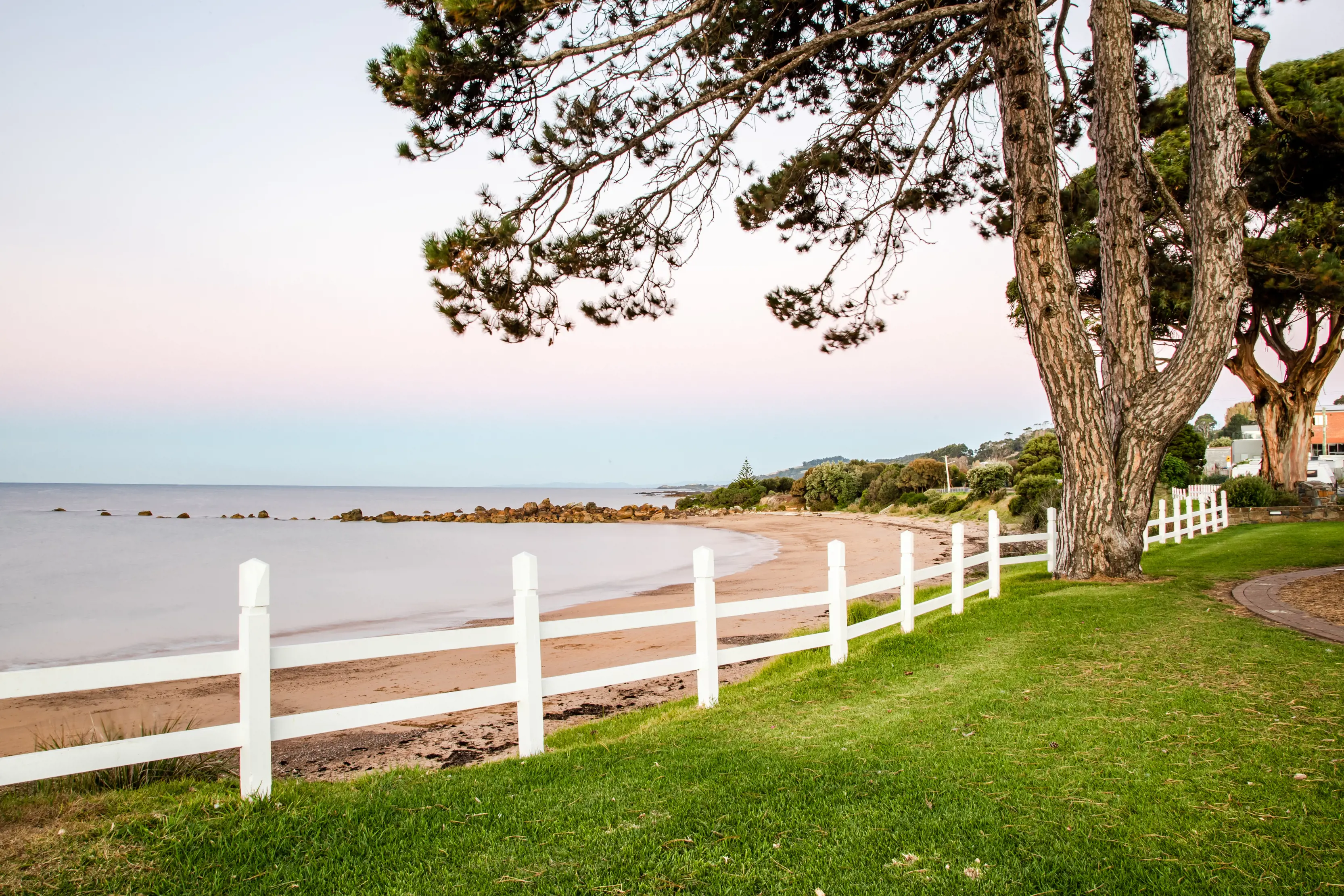 A beautiful image of Penguin foreshore, taken on dusk, displaying colourful pastel tones over the ocean.